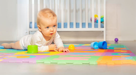 baby crawl on the floor next to a crib
