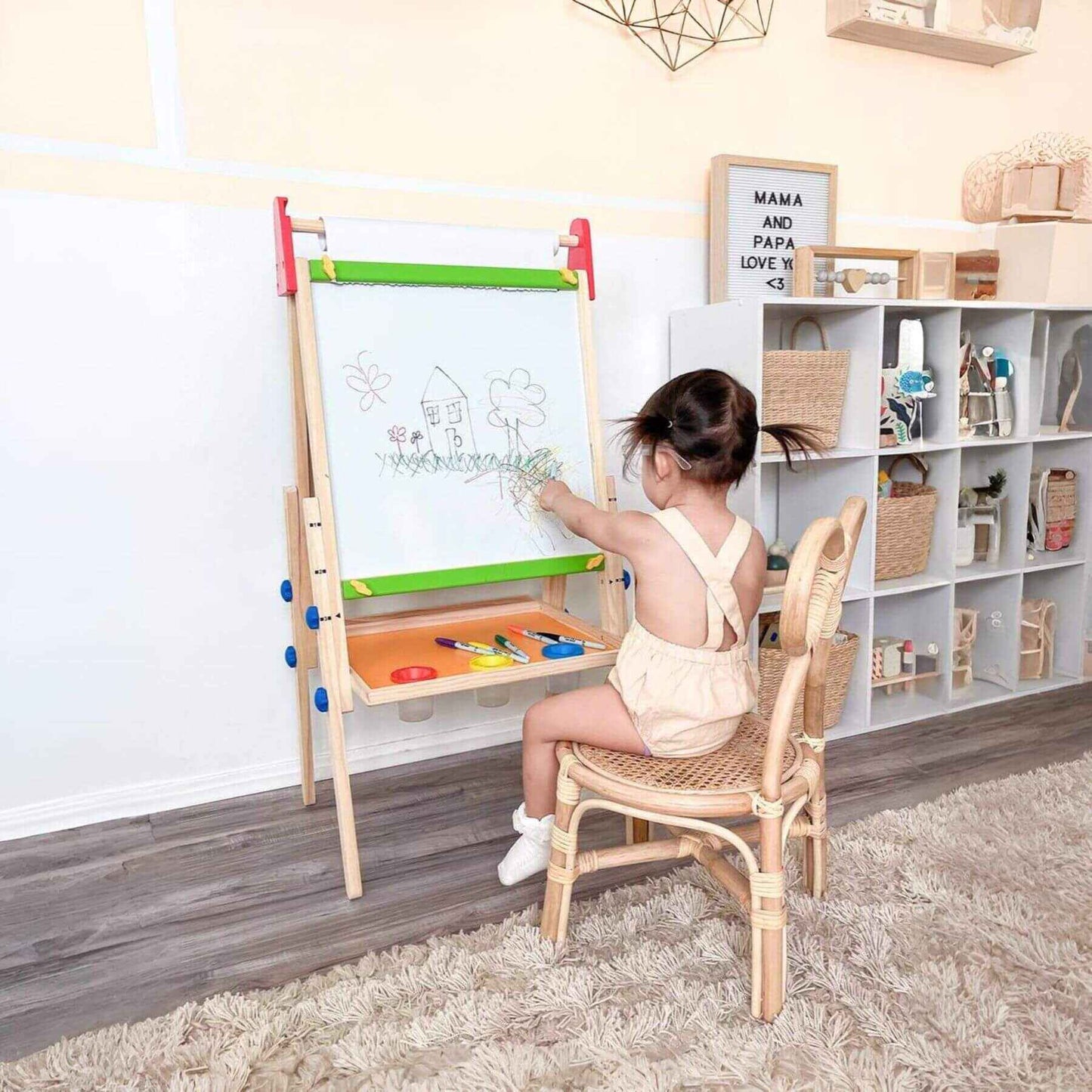 Child drawing on Tiny Land® 3-in-1 Art Easel & Paper Roll Set in a home setting