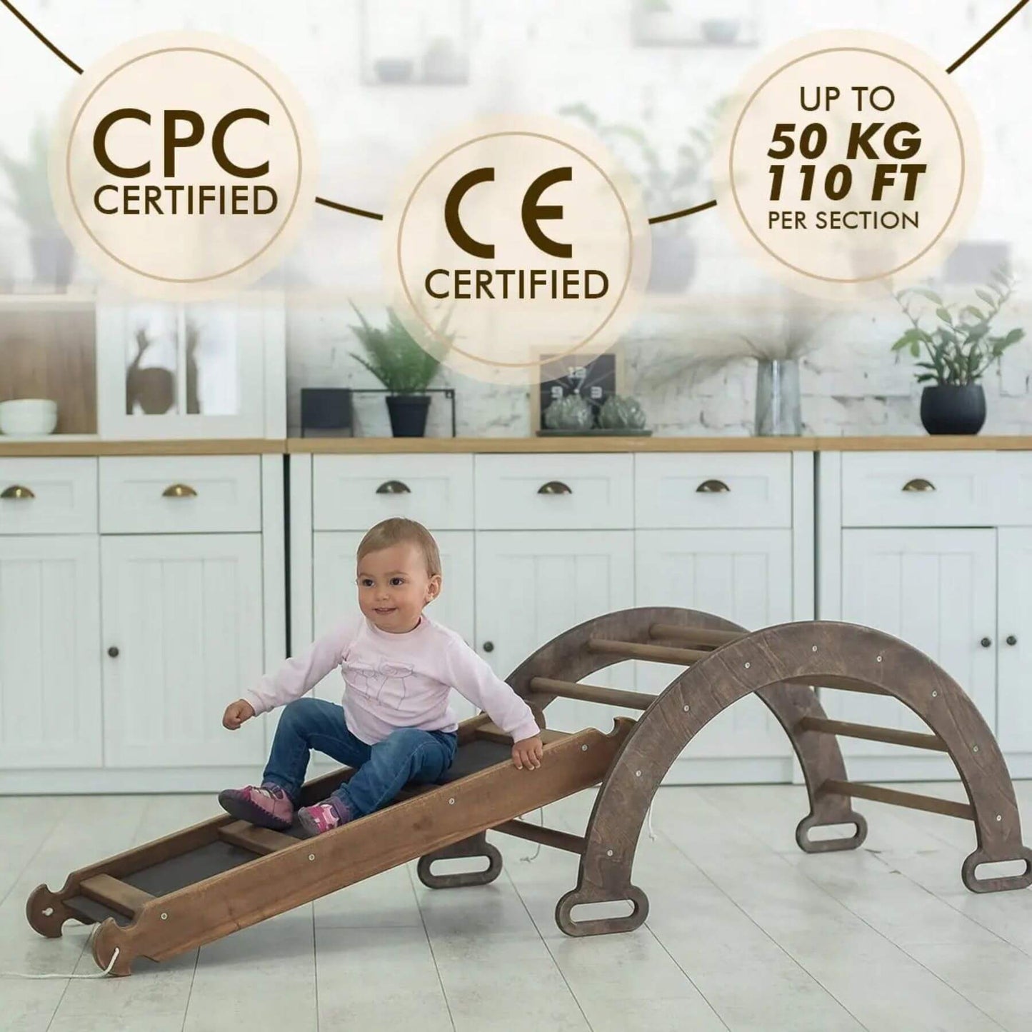 Child playing on Montessori Climbing Set in a kitchen with certification logos displayed.