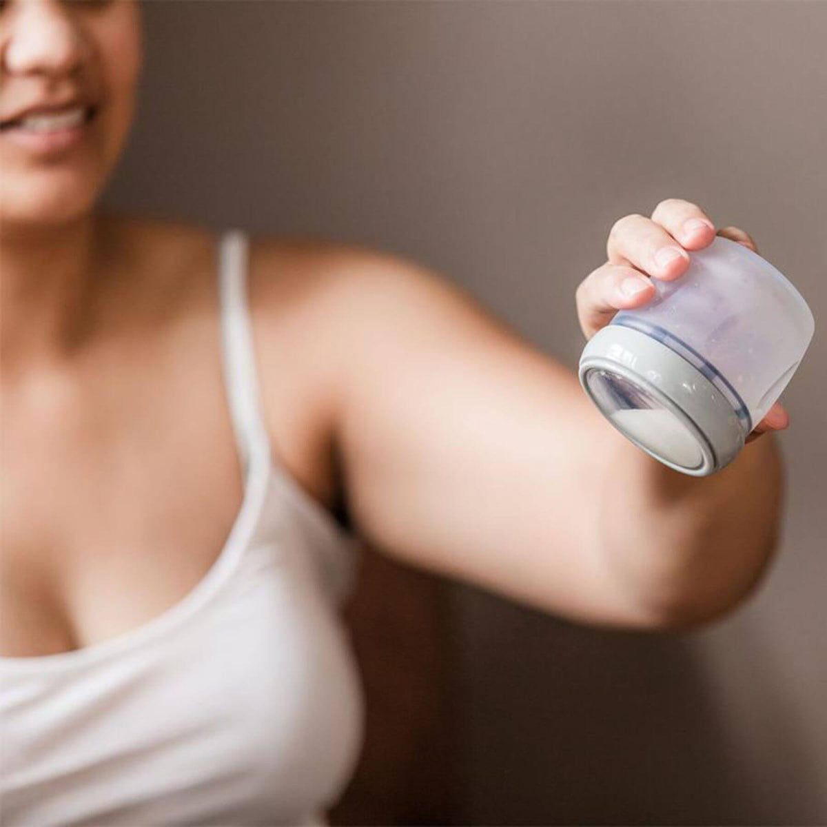 Woman holding a Haakaa Gen 3 Silicone Storage Container