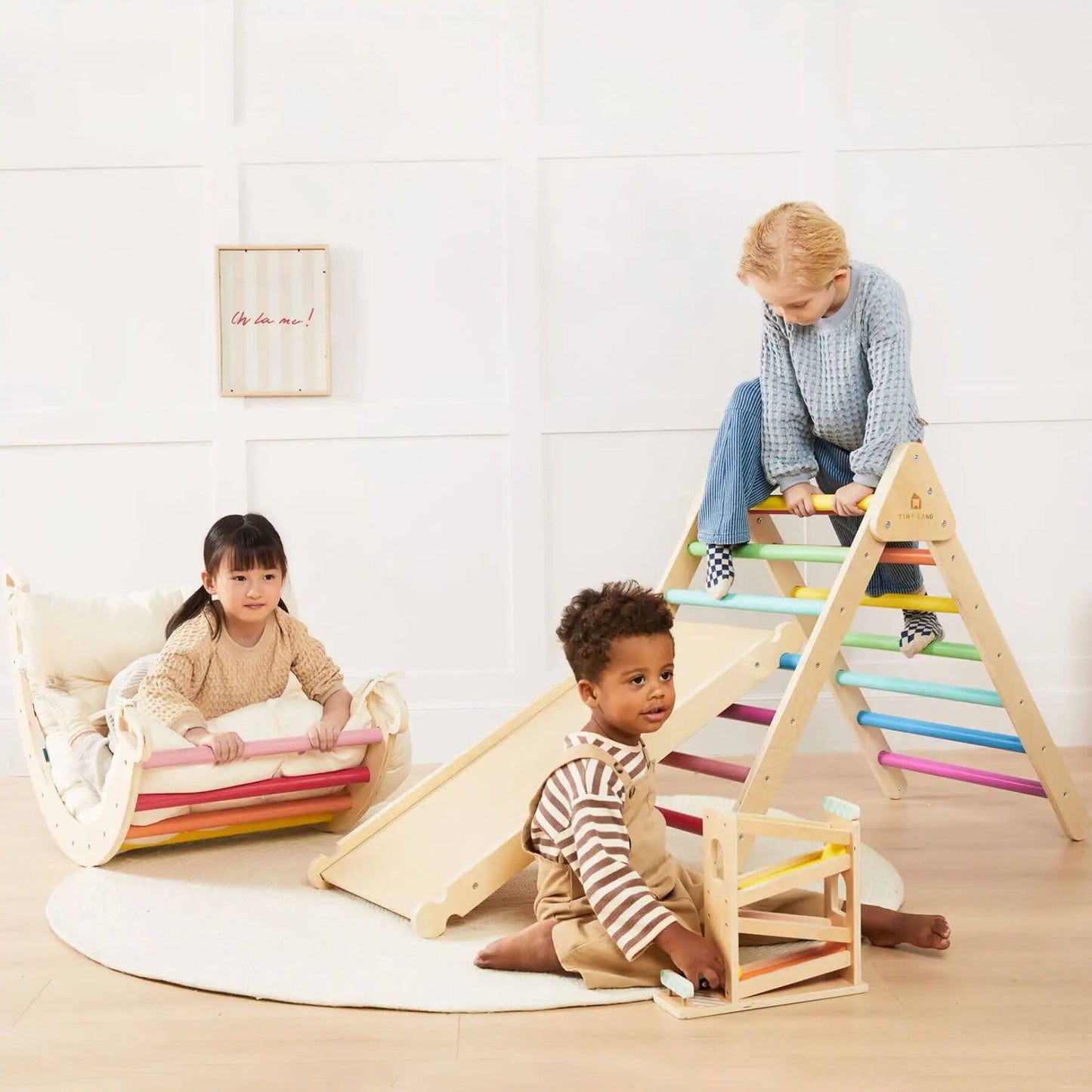 Children playing with Tiny Land® 7-in-1 Rainbow Climbing Set with Play Pad in a bright room.