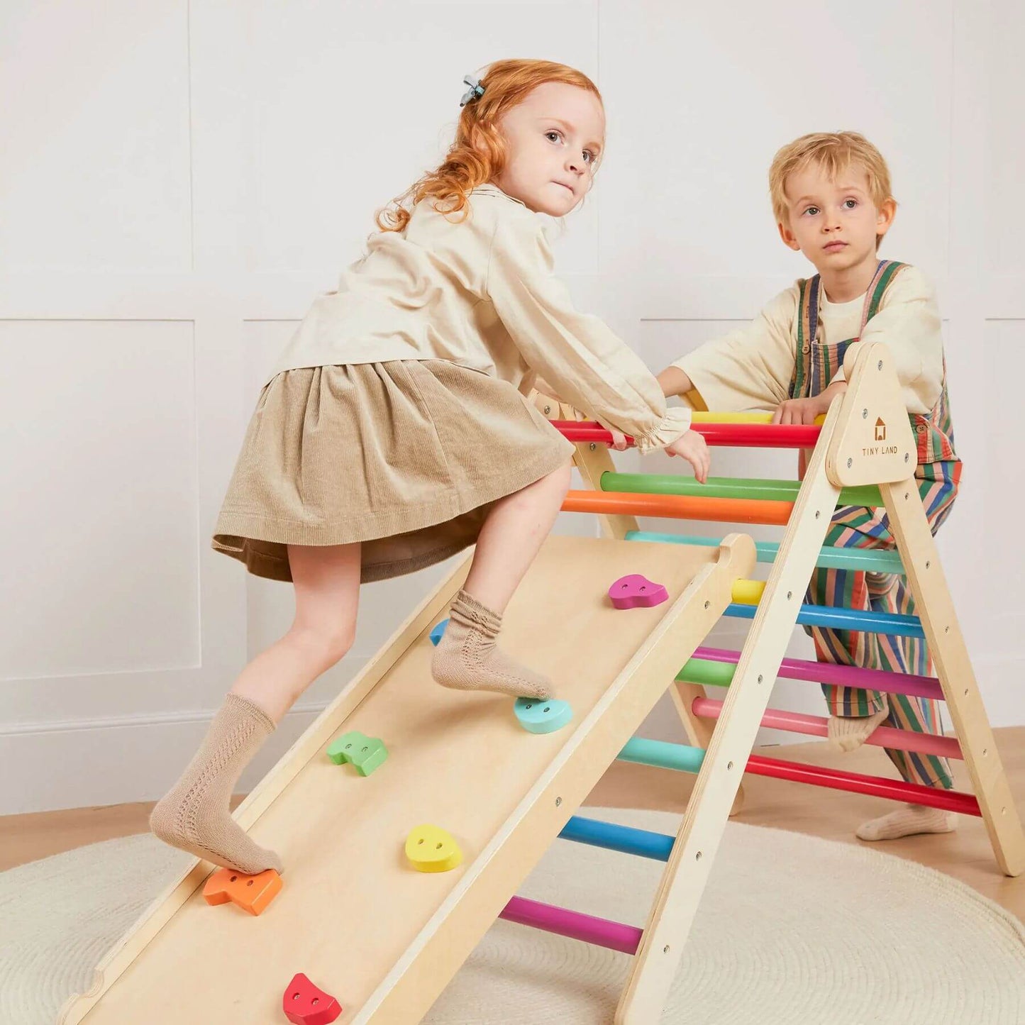Two children playing on Tiny Land® 7-in-1 Rainbow Climbing Set with Play Pad