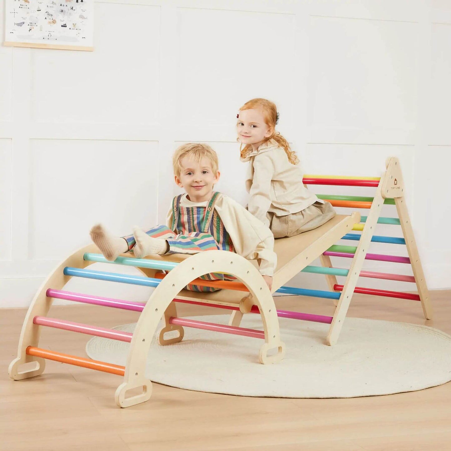 Two children playing on Tiny Land® 7-in-1 Rainbow Climbing Set with Play Pad indoors.