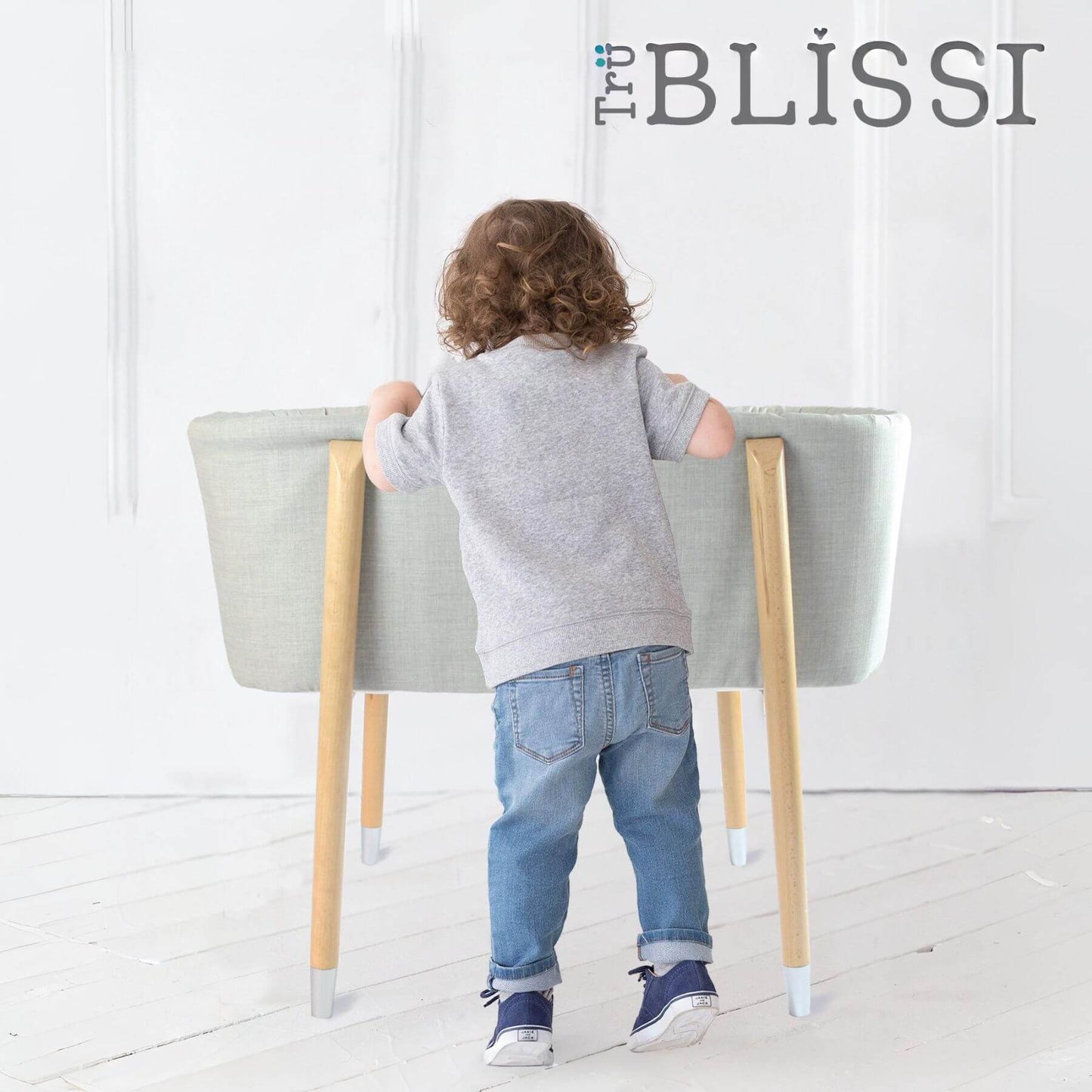 Kid Looking into TruBliss SOVA Bassinet Grey