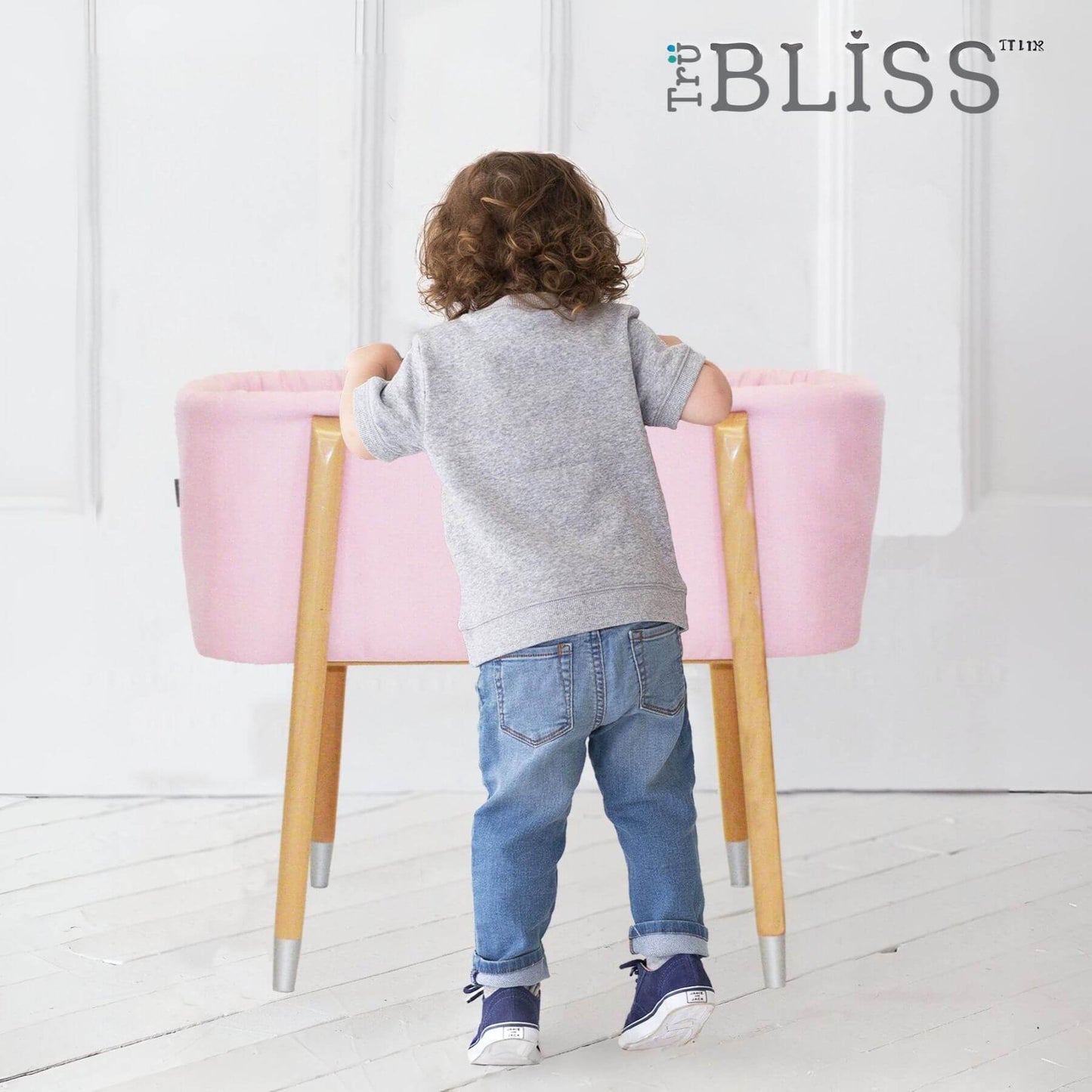 Kid Looking into TruBliss SOVA Bassinet Pink