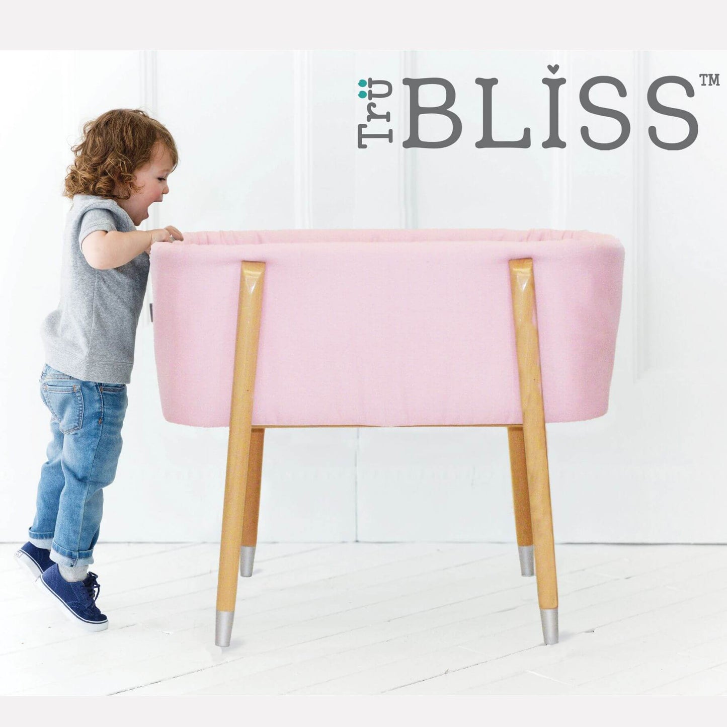 Kid Looking into TruBliss SOVA Bassinet Pink