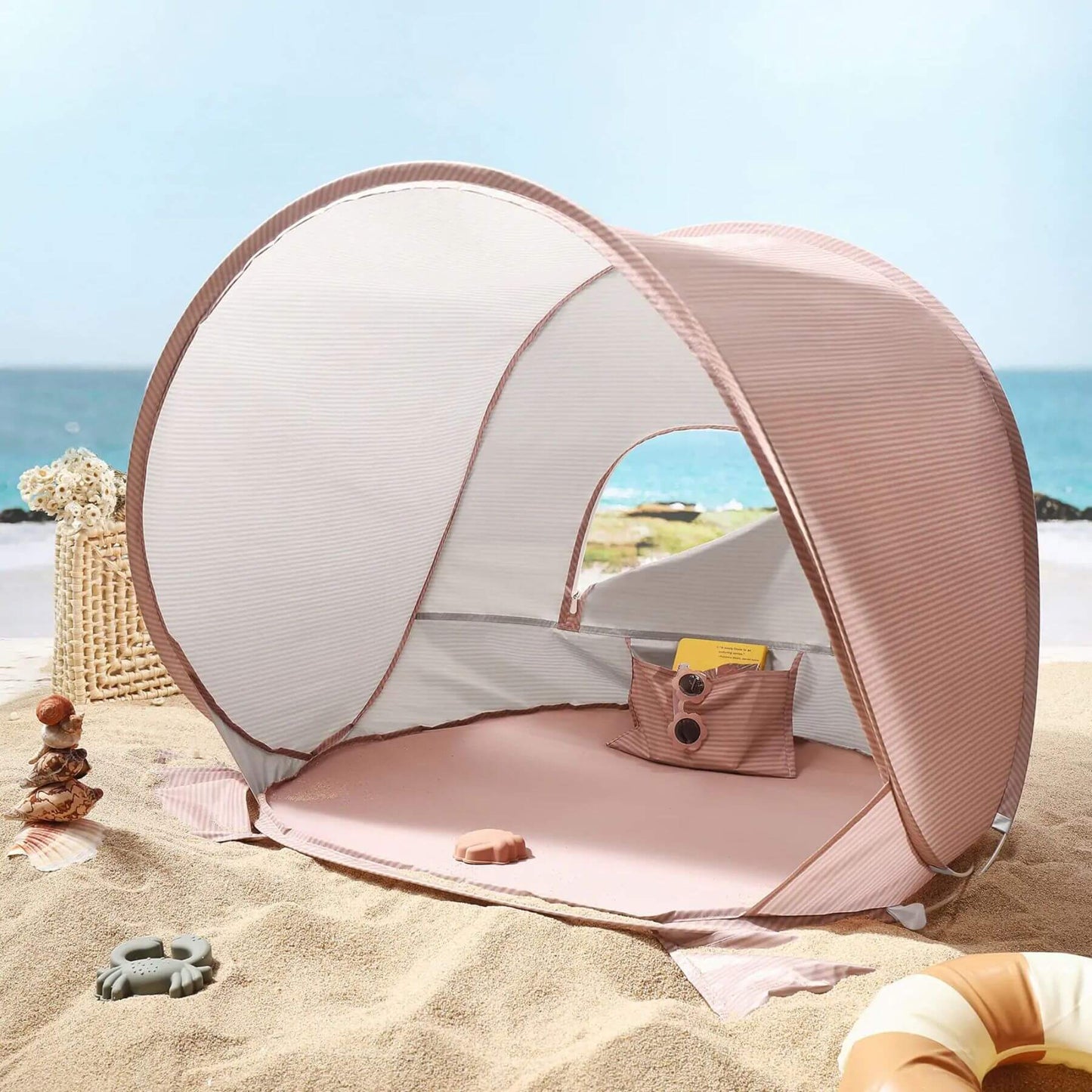 Portable beach tent on a sandy beach with ocean view