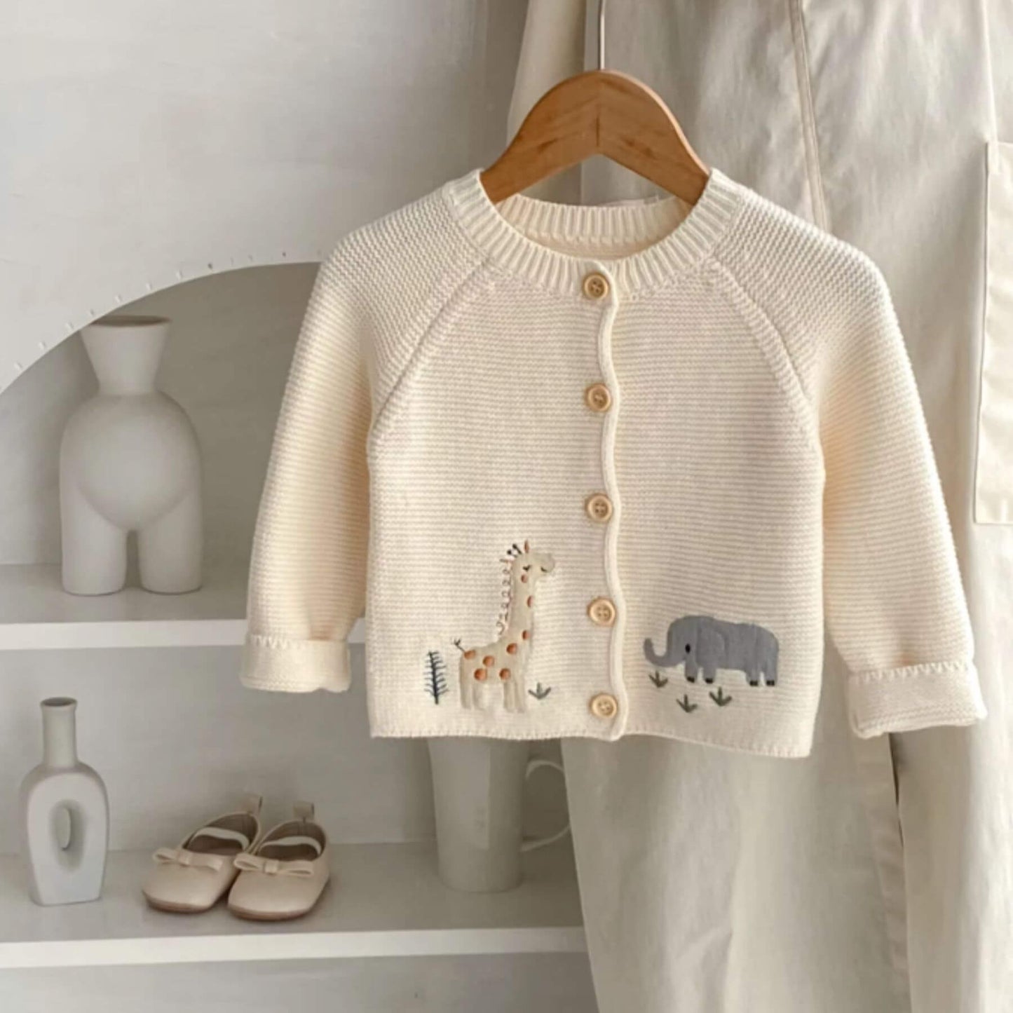 Animal Embroidery Sweater Cardigan on a wooden hanger against a white background.