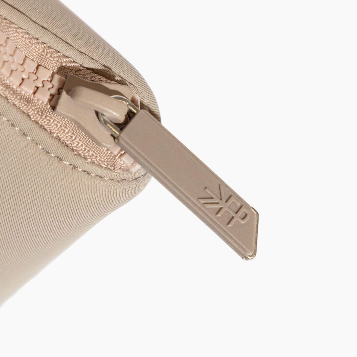 Close-up of a beige zipper on Freshly Picked Aspen Seoul Neoprene Backpack II