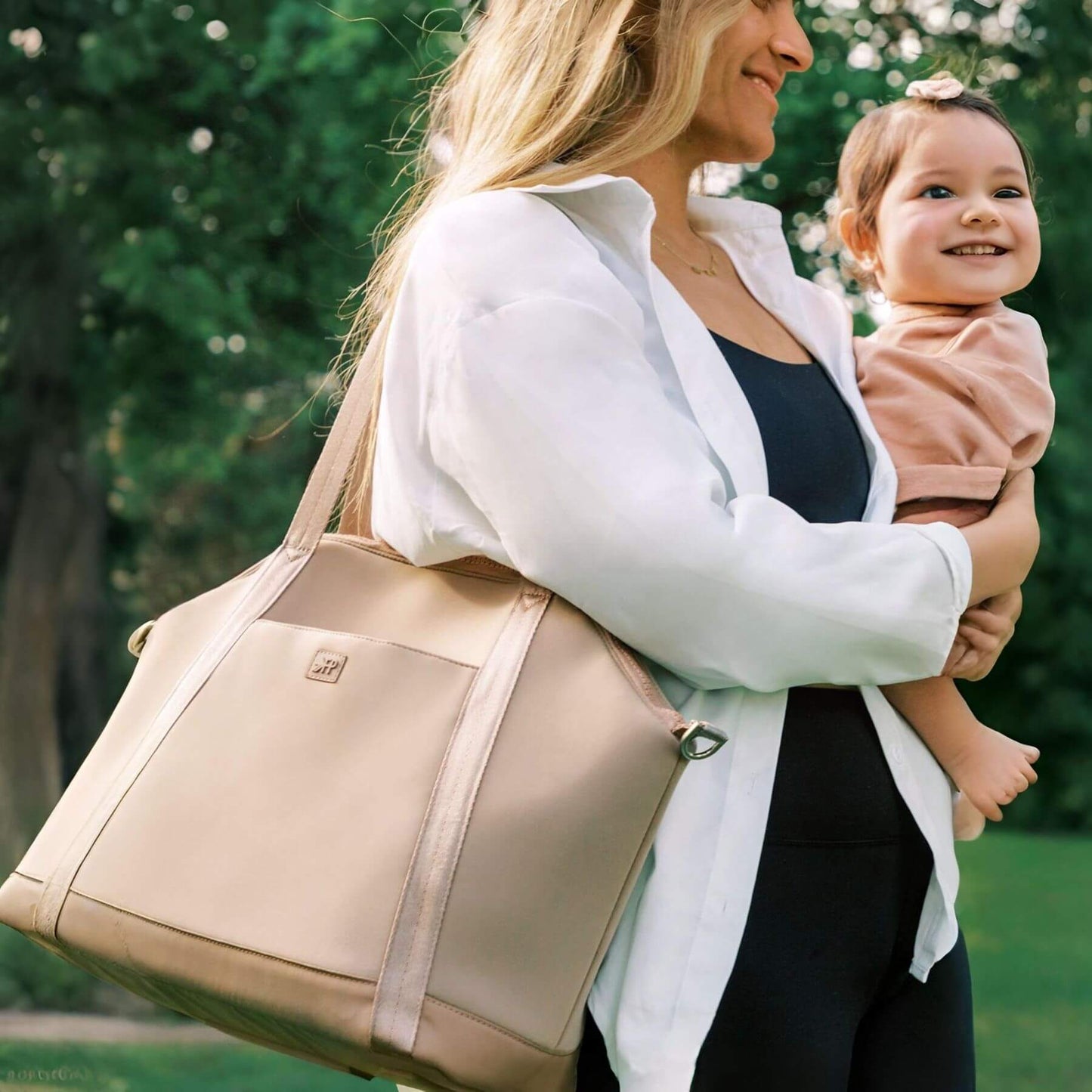 Woman holding Freshly Picked Aspen Seoul Neoprene Tote and a child outdoors