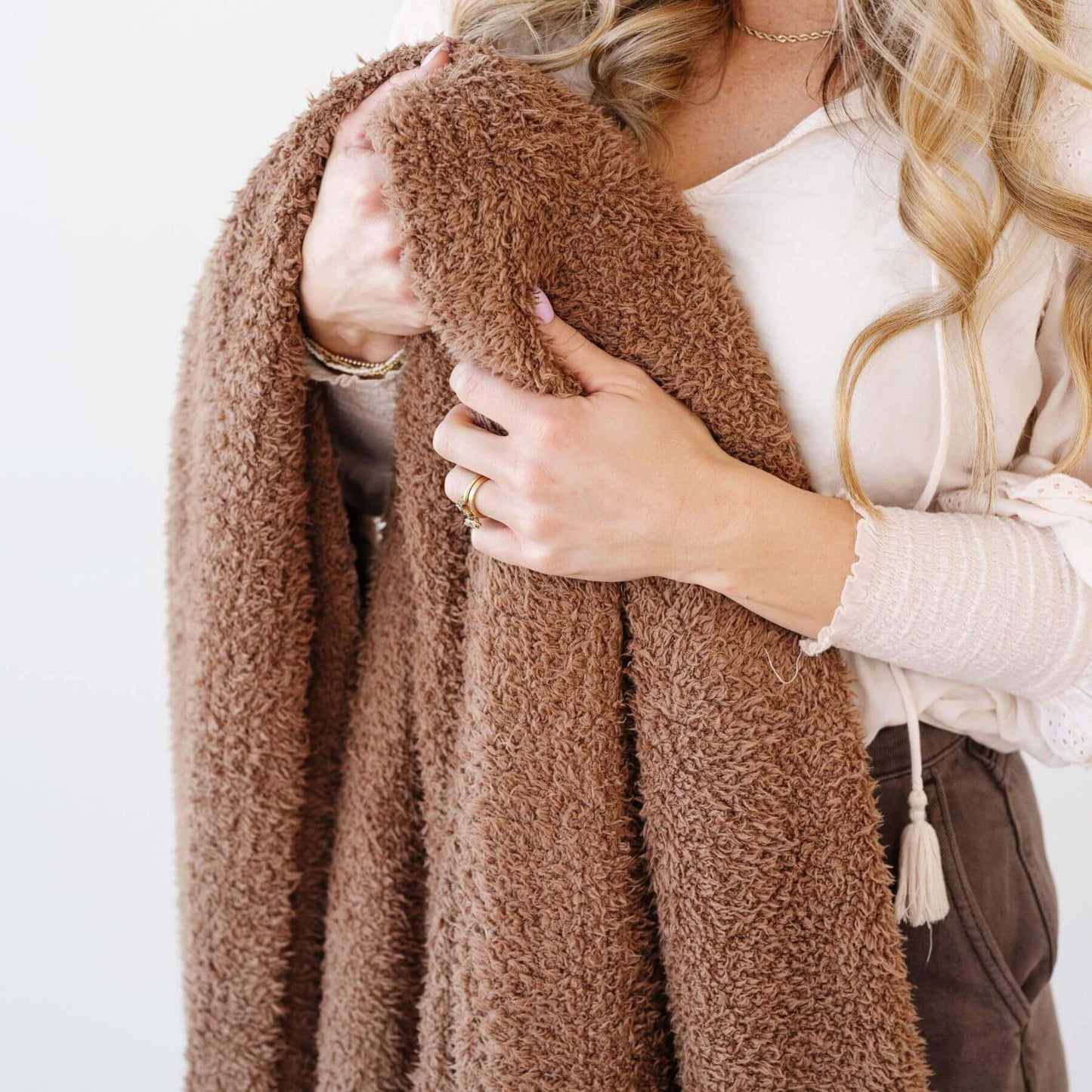 Person holding Saranoni Bamboni® Throw Blanket against a white background