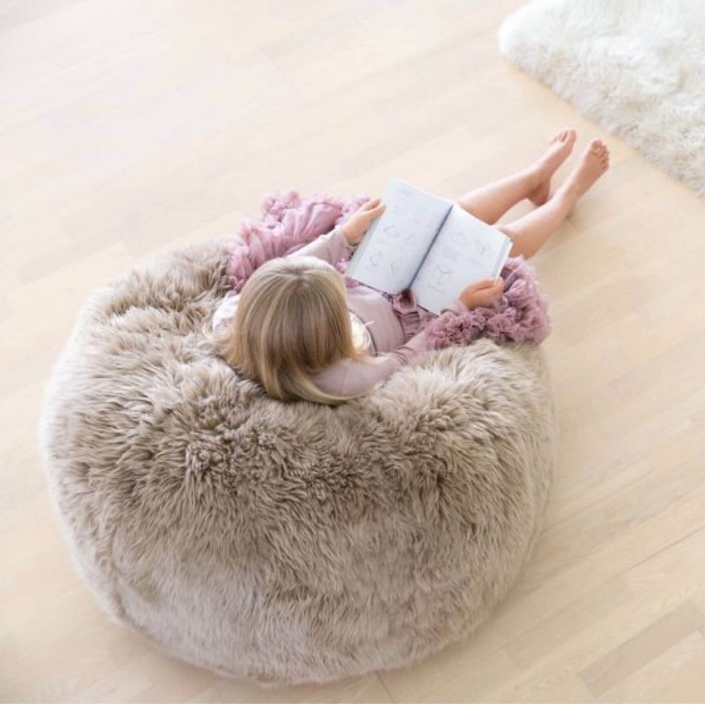 Girl Sitting on Bean Bag Chair, New Zealand Sheepskin, LW, Light Grey
