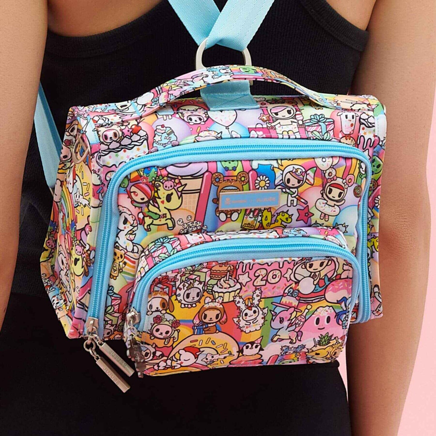 tokidoki The Bestie Small Messenger Handbag held by a person.