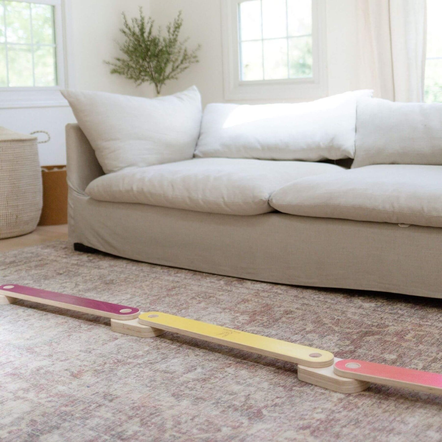 Bunny Hopkins Balance Beam on a carpeted floor with a beige sofa in the background