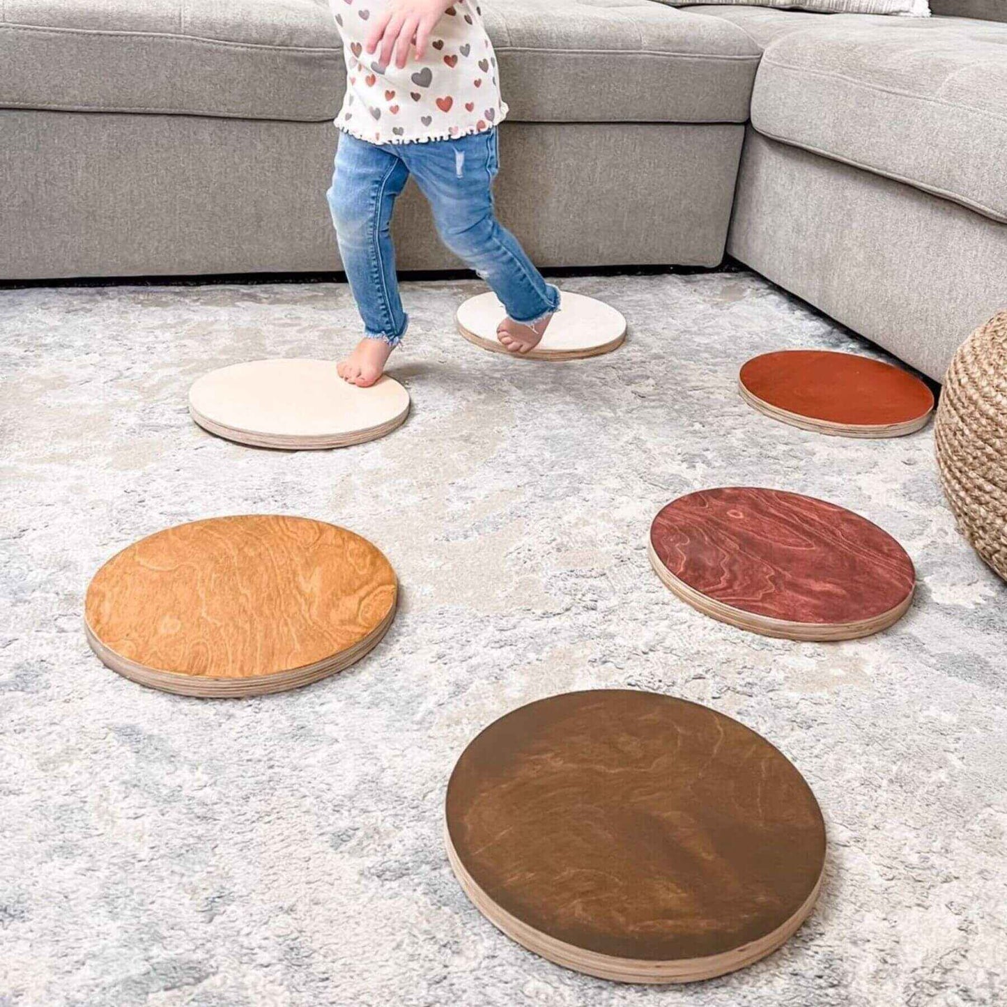 Child stepping on Bunny Hopkins Stepping Stones in a living room setting