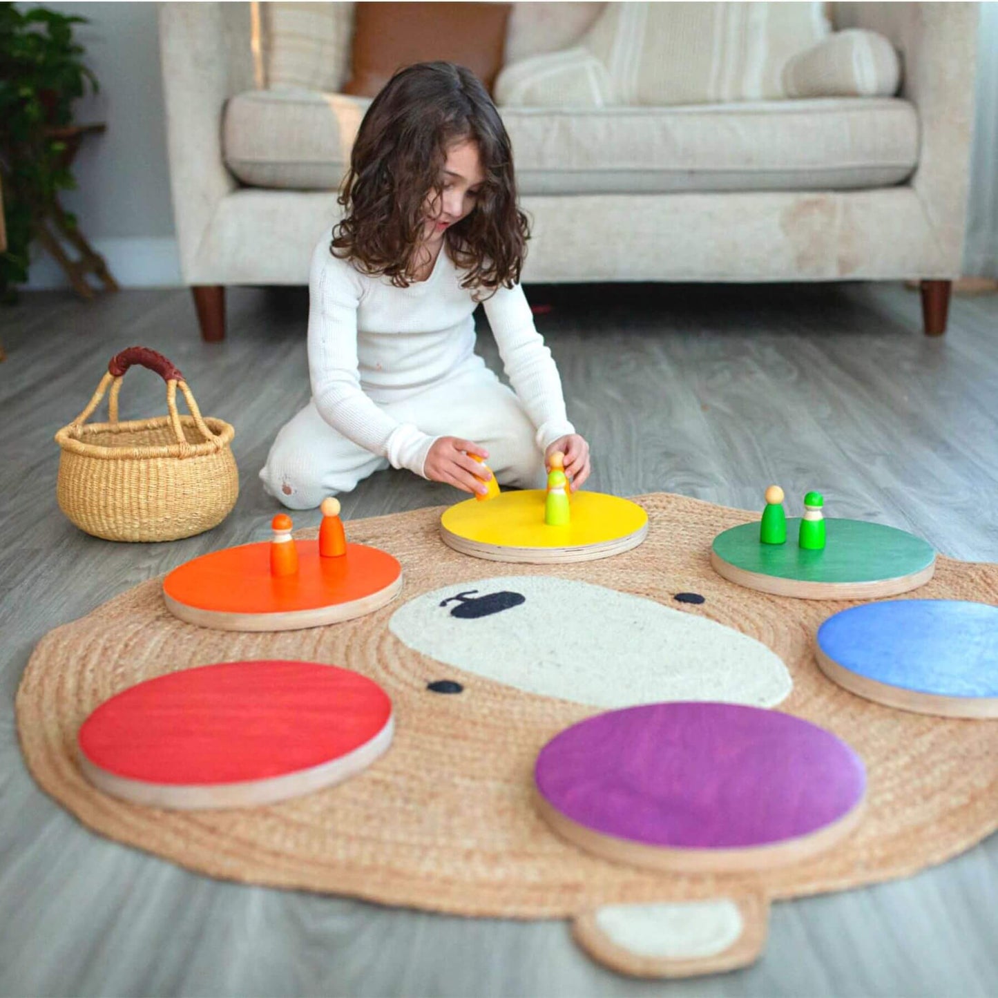 Child playing with Bunny Hopkins Stepping Stones on a mat in a living room.