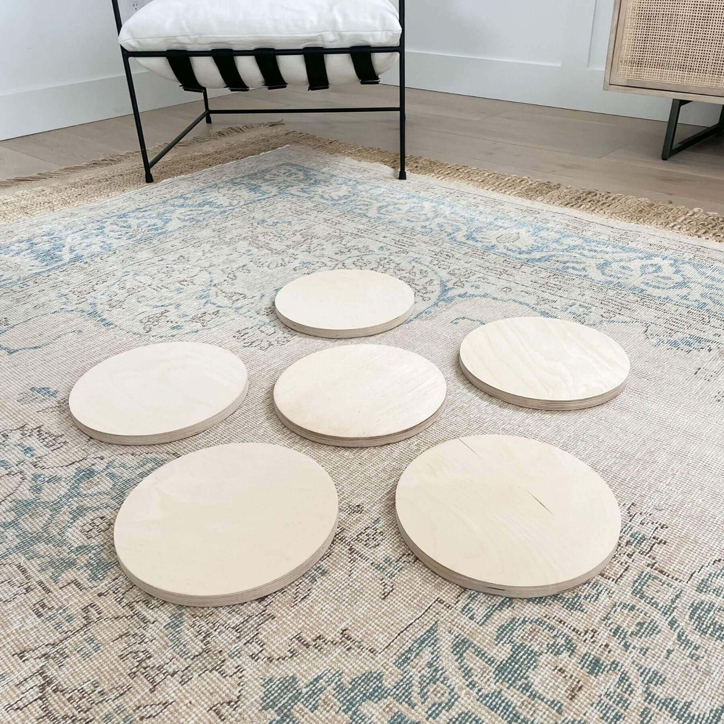 Bunny Hopkins Stepping Stones on a patterned rug in a room with a bench and lamp.