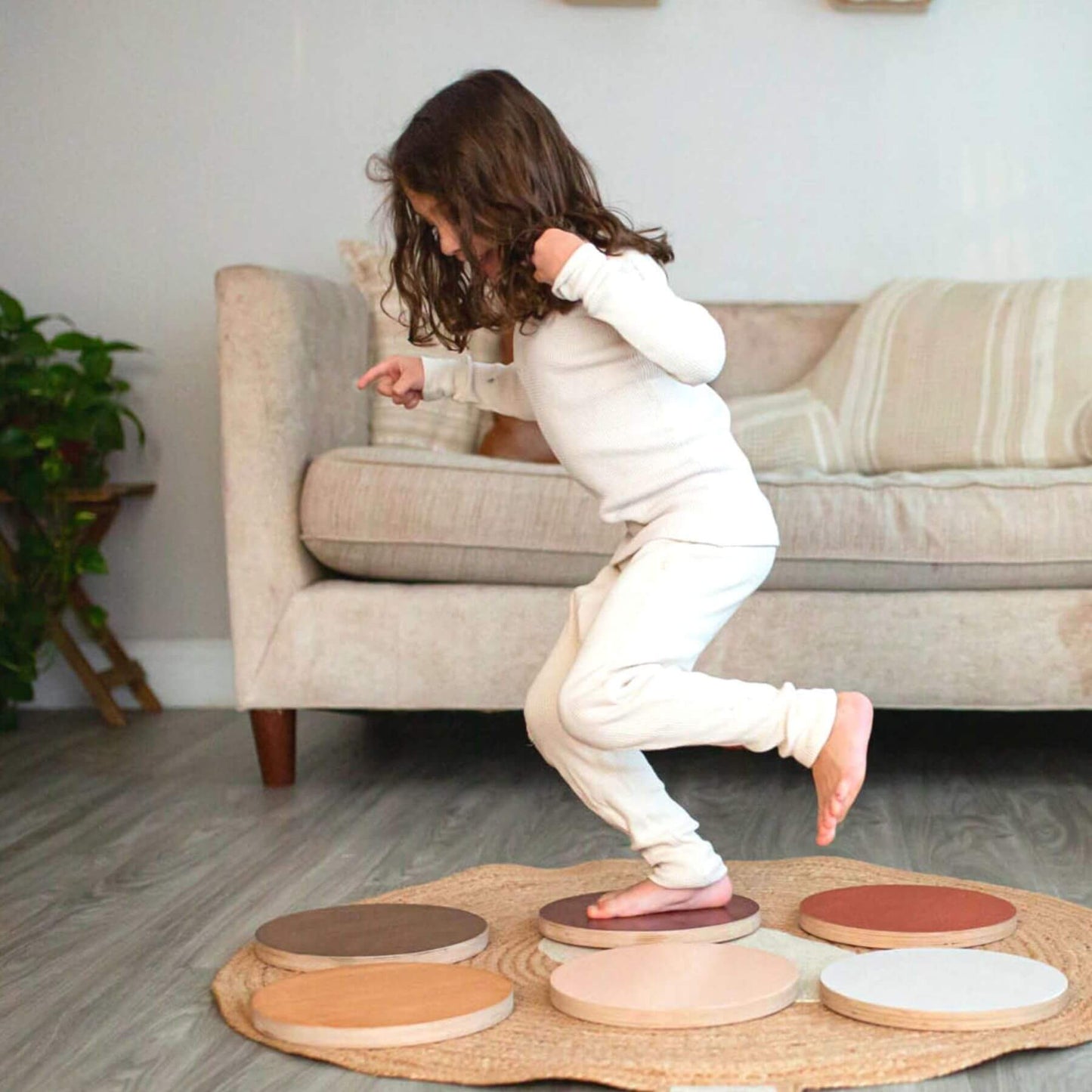 Child playing with Bunny Hopkins Stepping Stones in a living room.