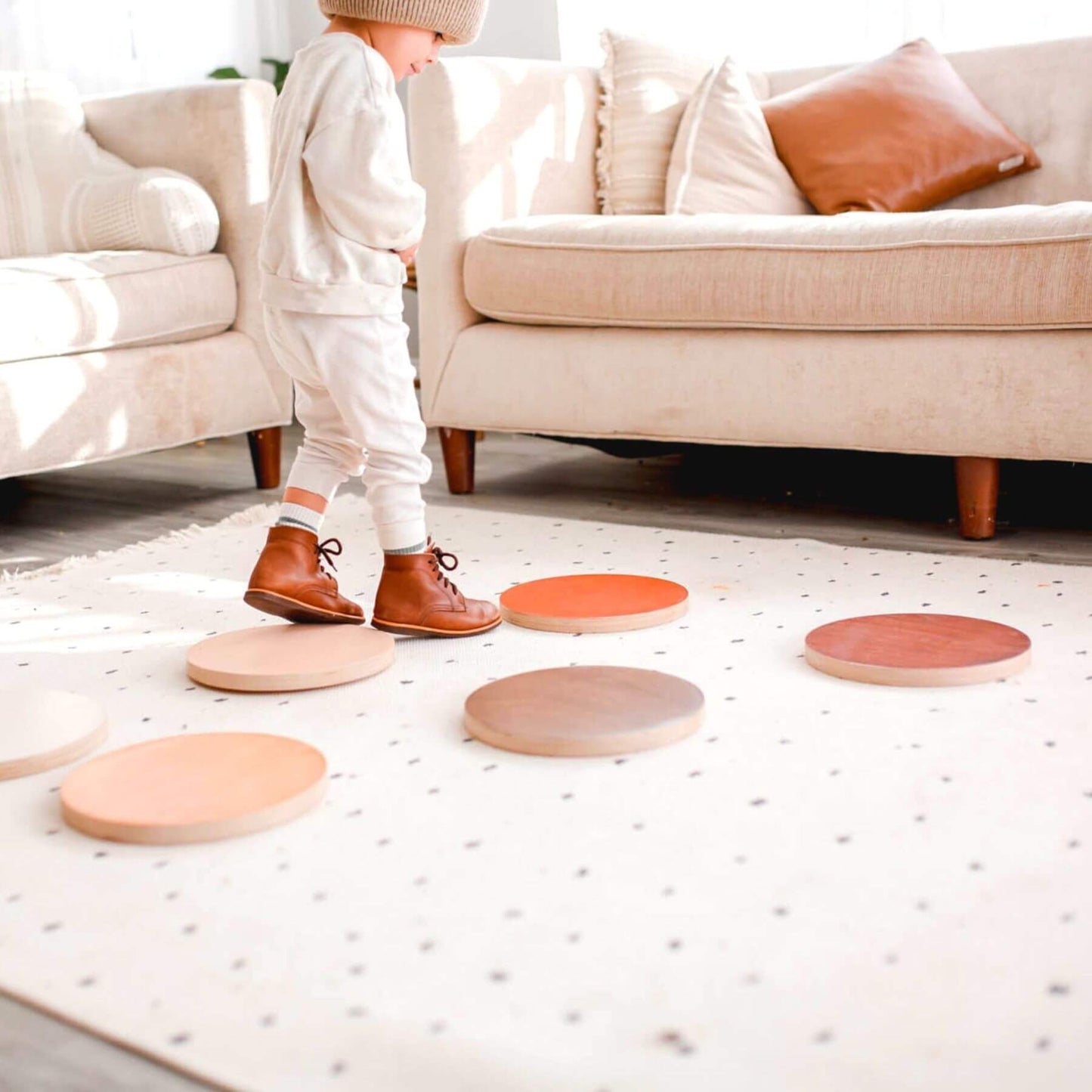 Child playing with Bunny Hopkins Stepping Stones on a light-colored floor.
