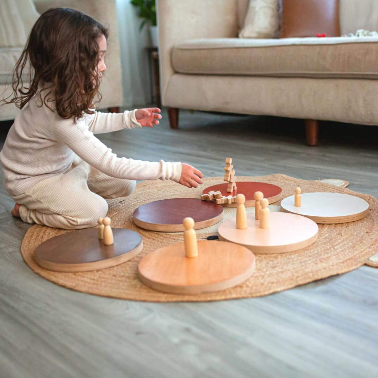 Child playing with Bunny Hopkins Stepping Stones on a mat in a living room.