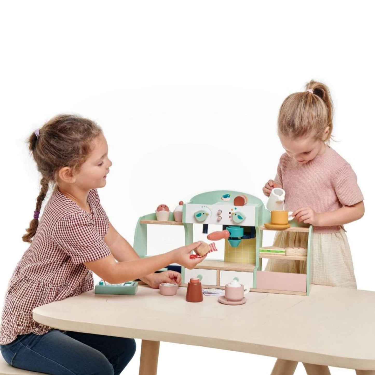 Two children playing with Tender Leaf Bird’s Nest Café on a table.