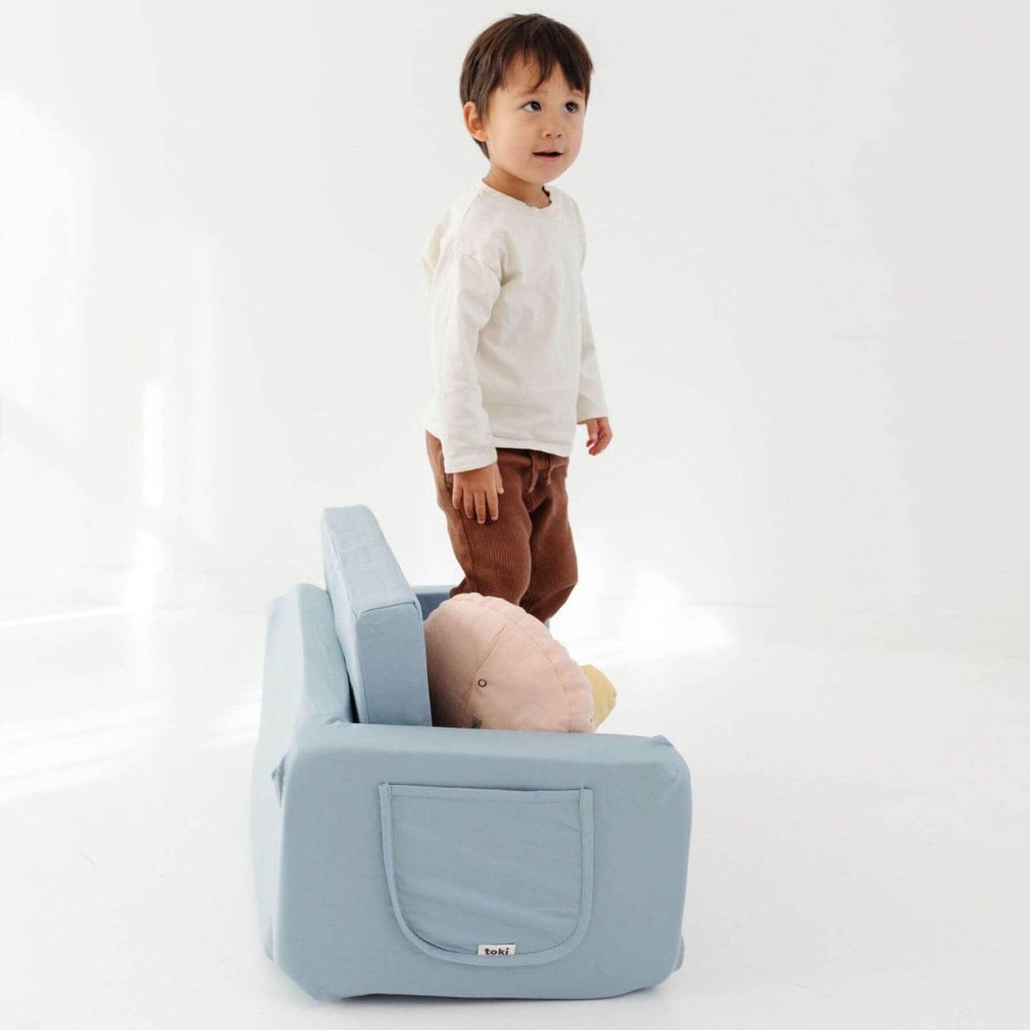 Child standing next to Toki Kids Breeze Play Couch