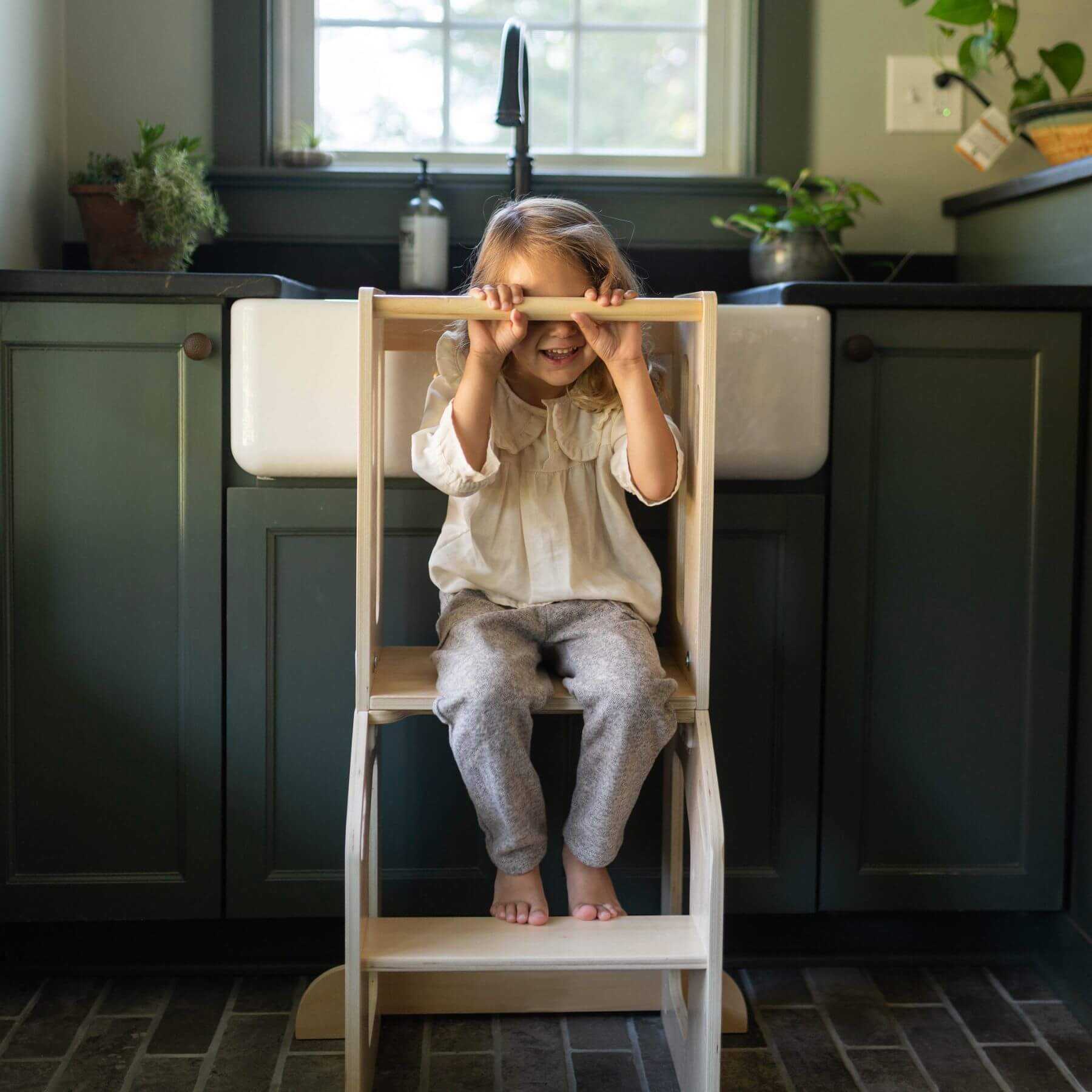 Girl Sitting on Busy Kids 2-In-1 Kitchen Tower and Kids Art Desk
