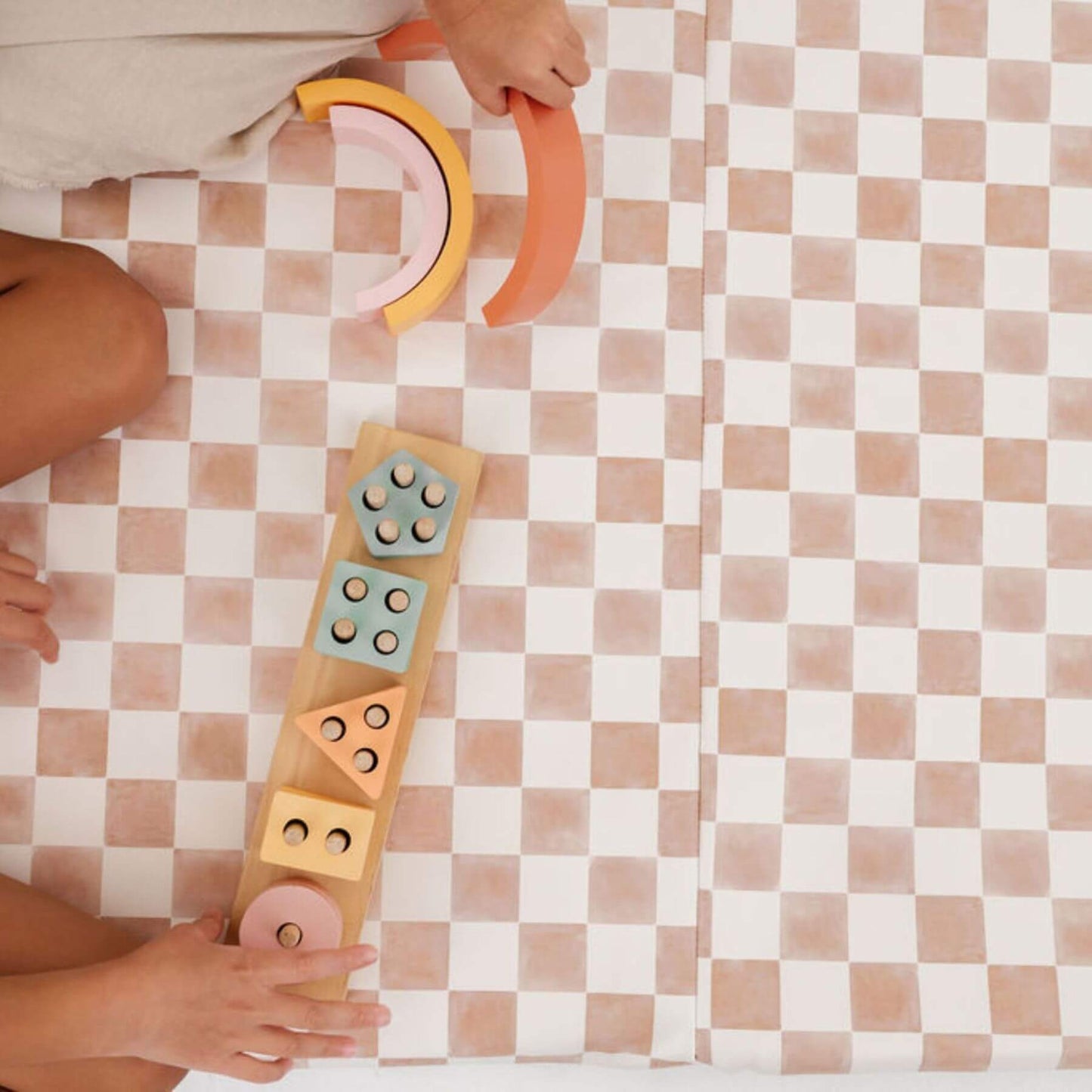 Children playing with colorful wooden shape sorting toys on Toki Kids Checker Toffee Vegan Leather Mat