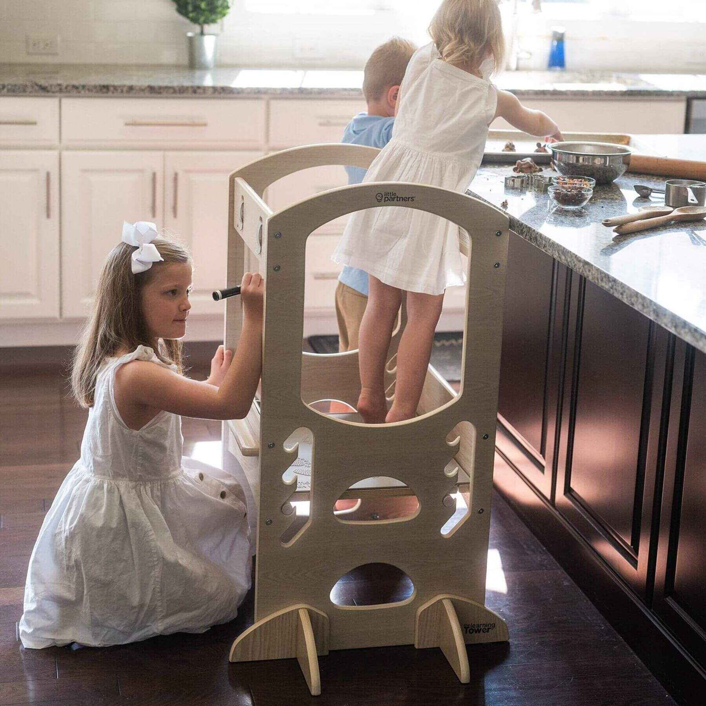 Girl Standing on Little Partners Chef Series Learning Tower Natural, Playing with siblings