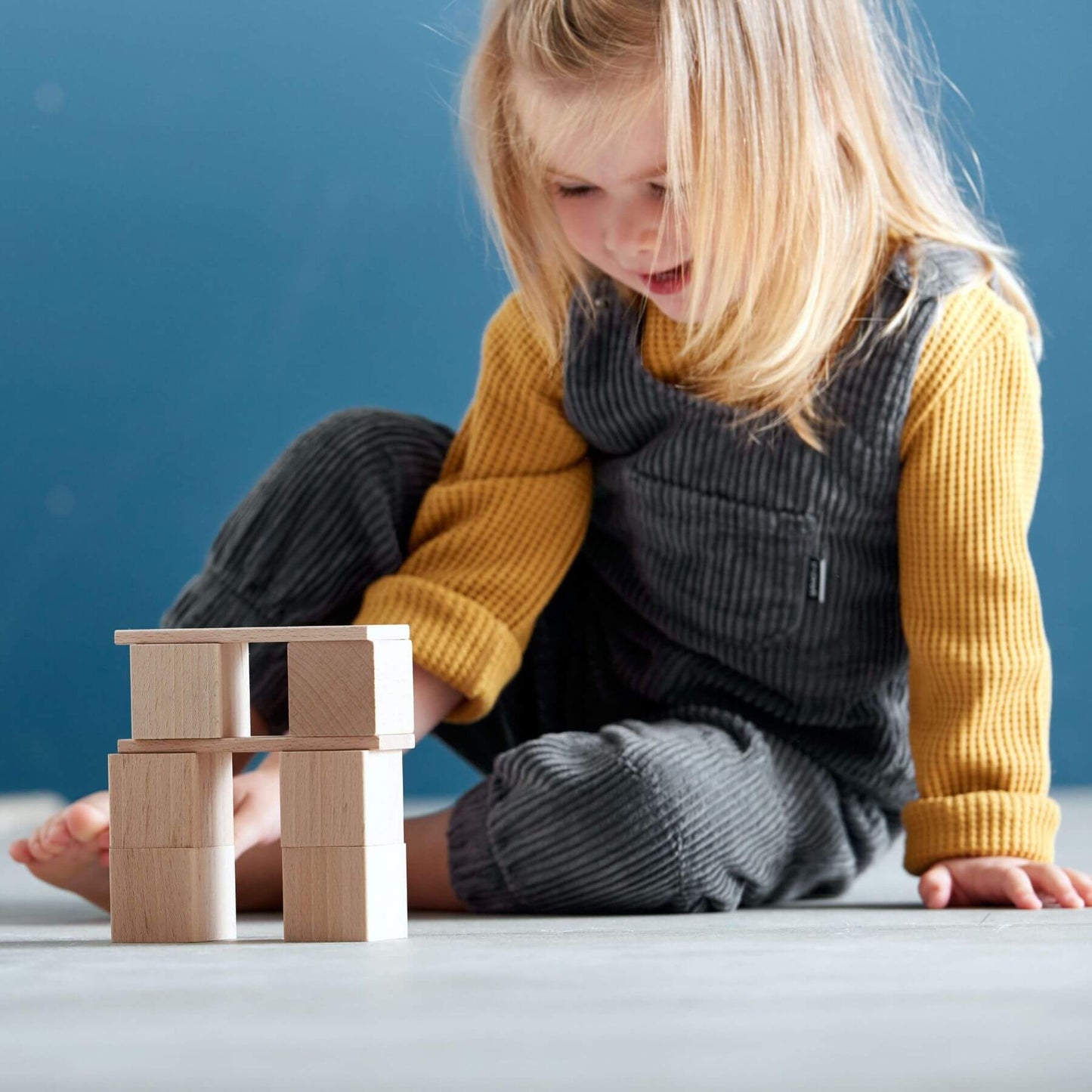 Child playing with HABA USA Clever Up! Building Block System 2.0