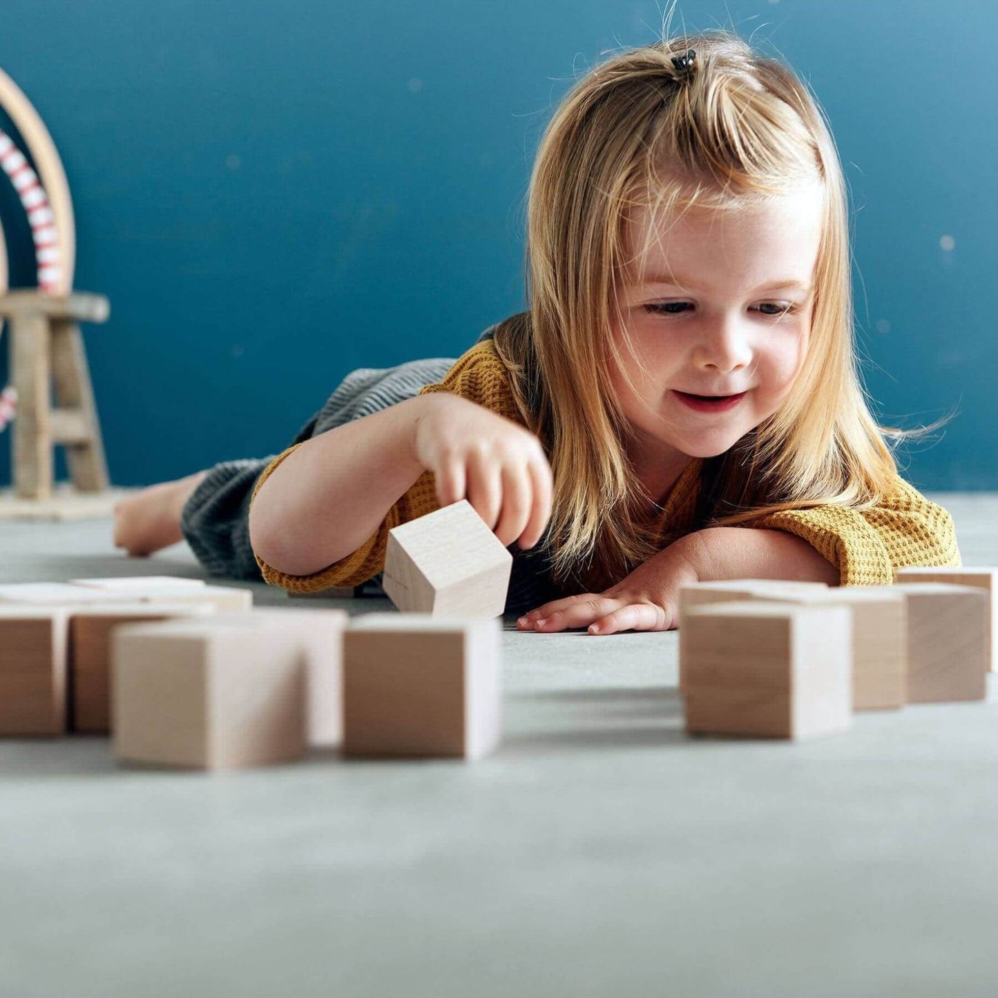 Child playing with HABA USA Clever Up! Building Block System 2.0