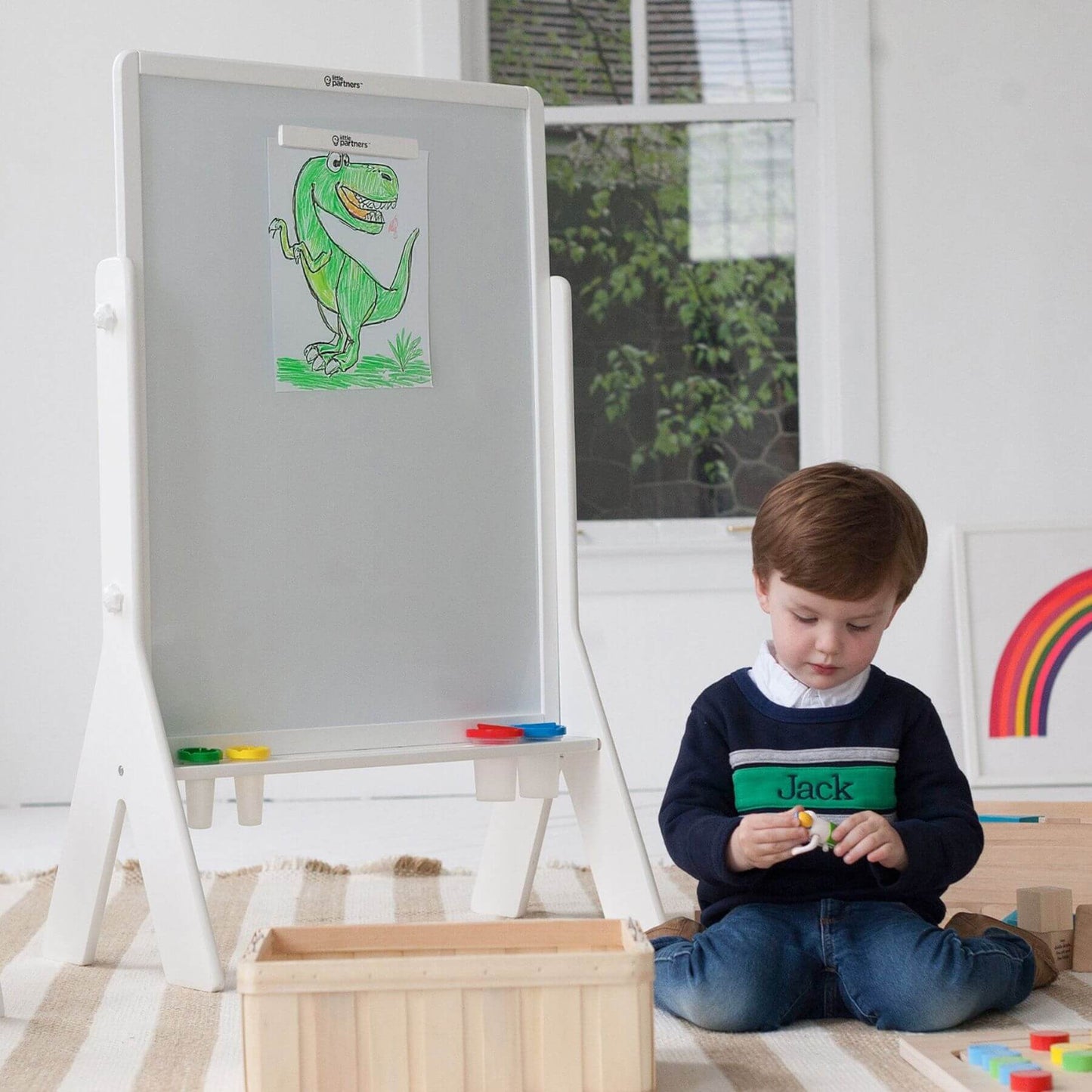 Boy Sitting next to Little Partners Contempo Art Easel White
