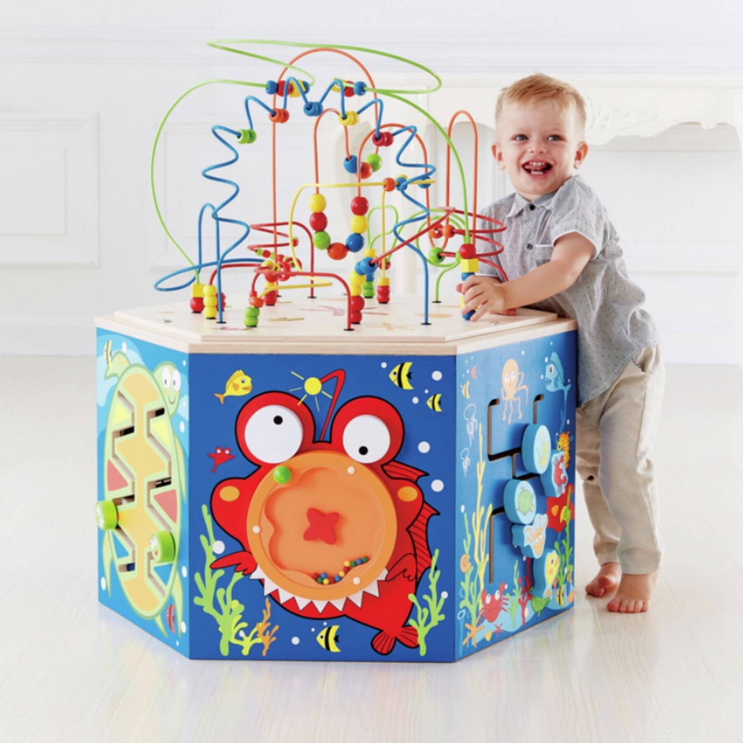 Child playing with Hape Coral Reef Activity Center