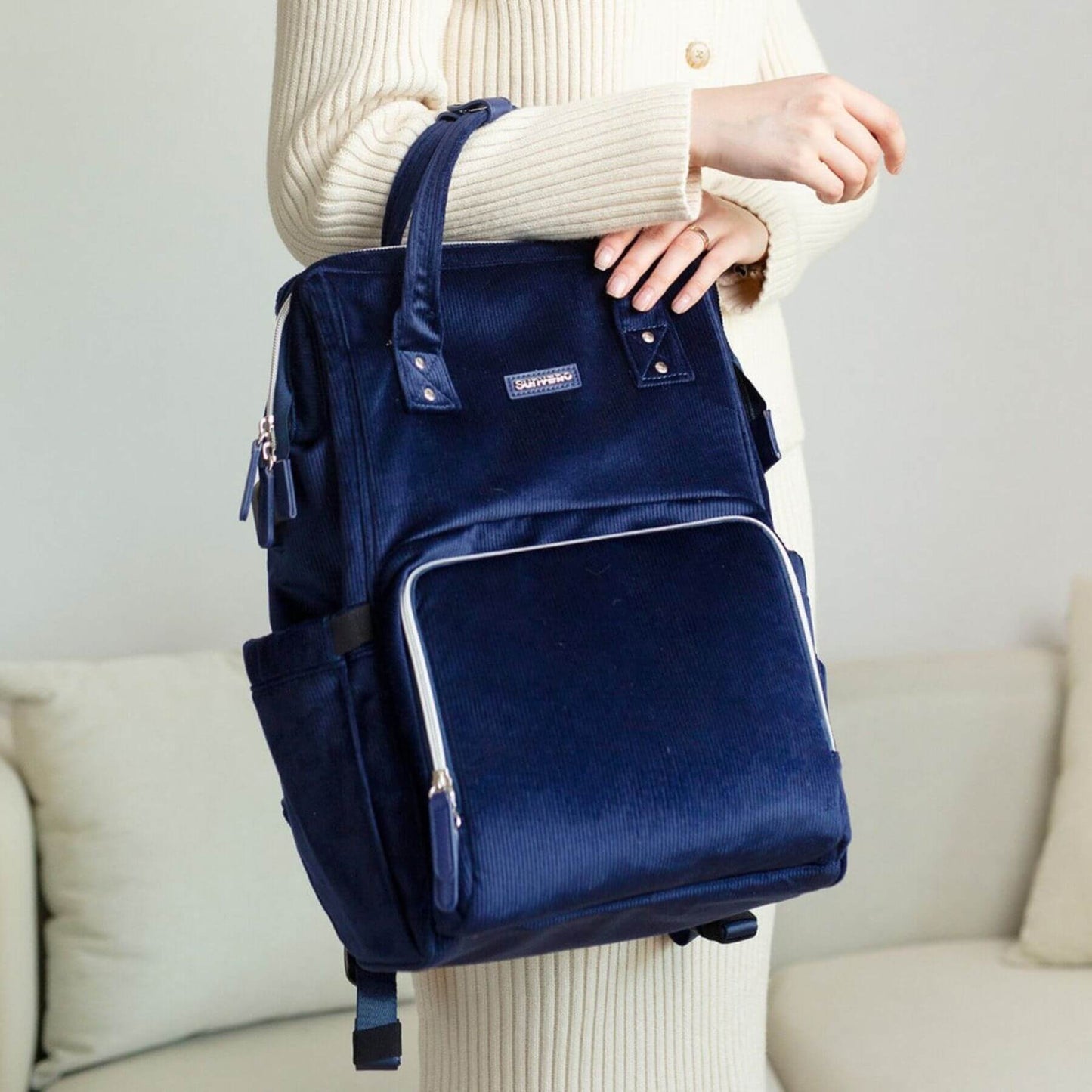 Person holding Corduroy Diaper Backpack Blue on a neutral background