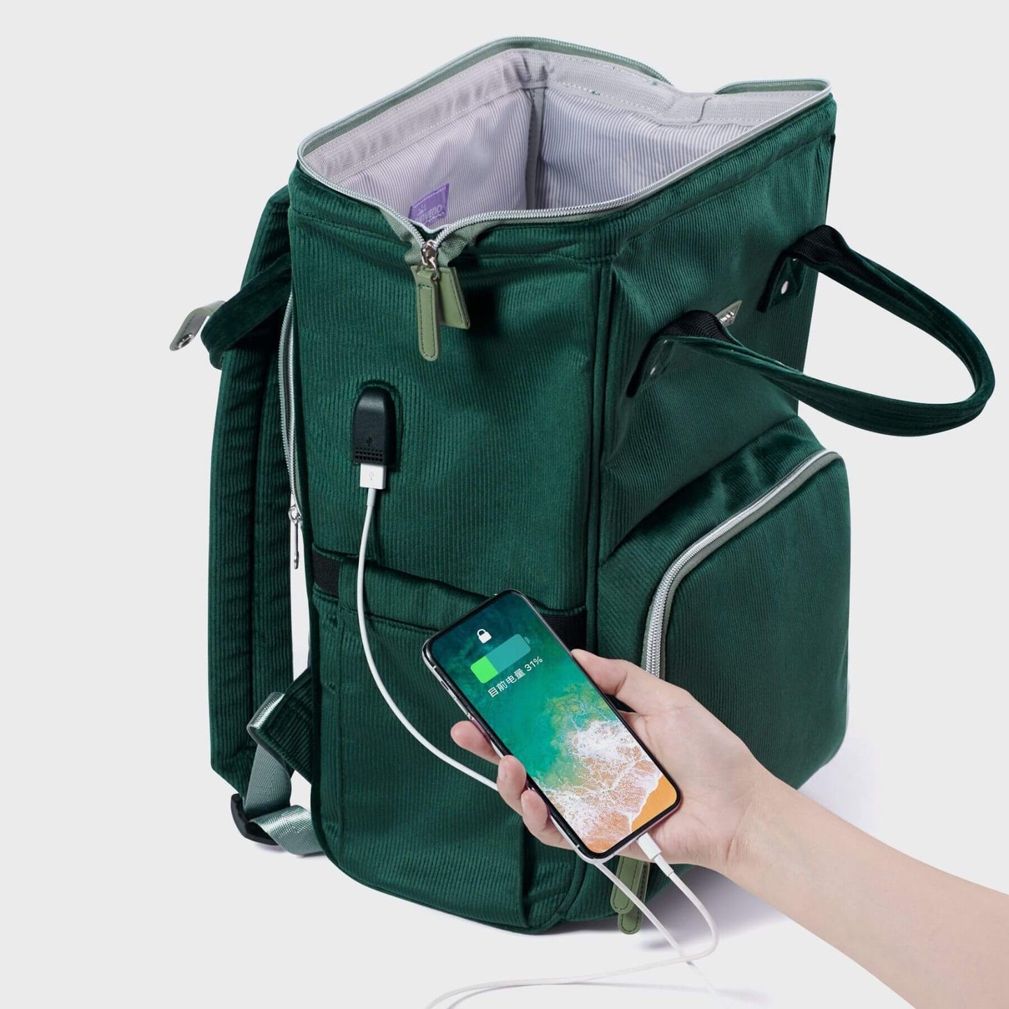 Corduroy Diaper Backpack with a phone being charged