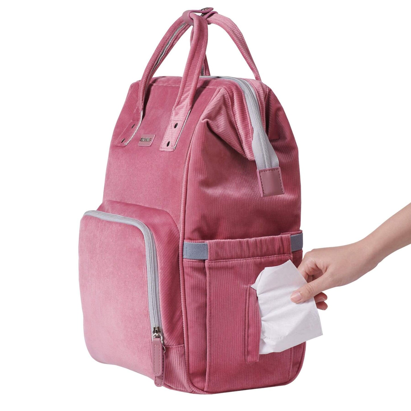 Corduroy Diaper Backpack Pink with a hand holding tissues