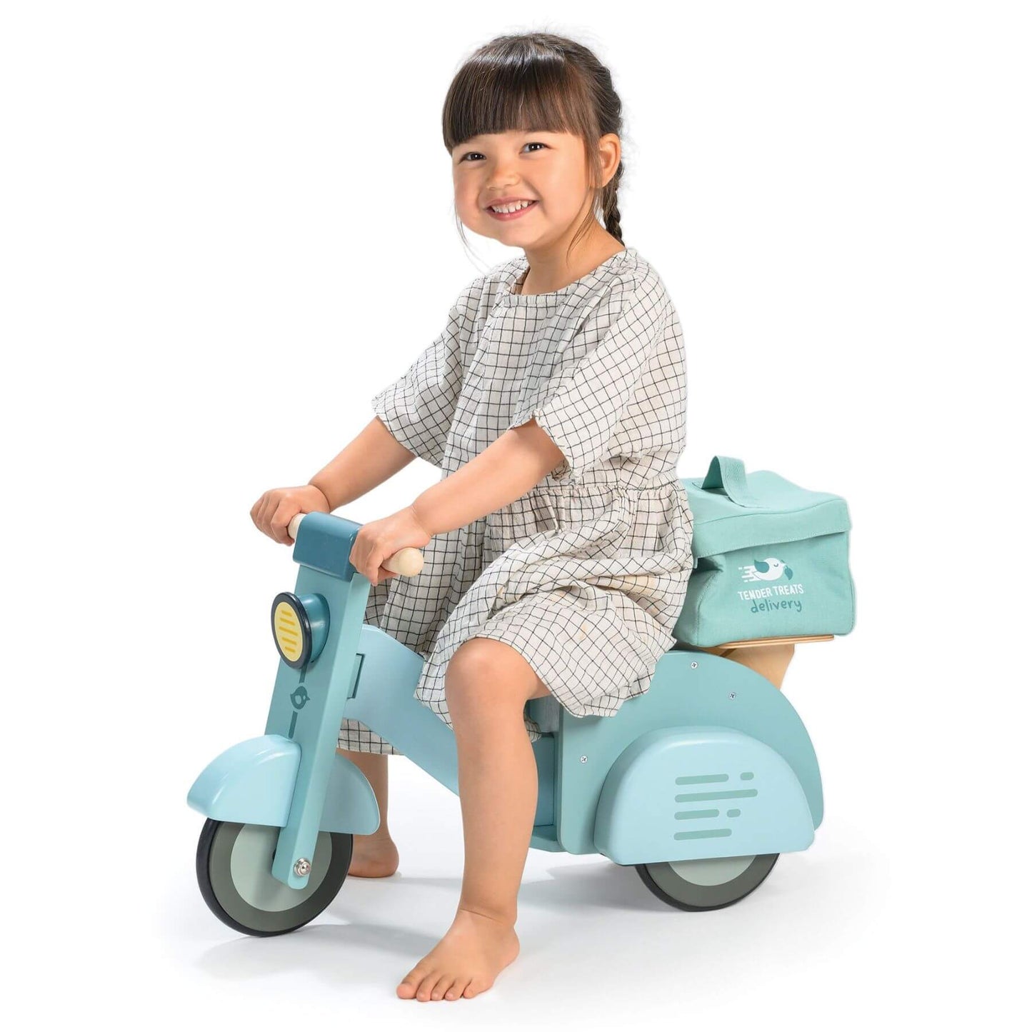 Child sitting on Tender Leaf Delivery Scooter with a white background