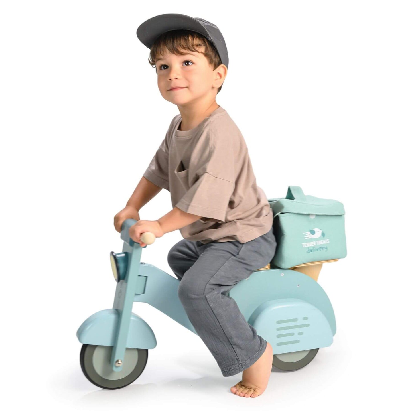 Child riding Tender Leaf Delivery Scooter with a small bag on a white background