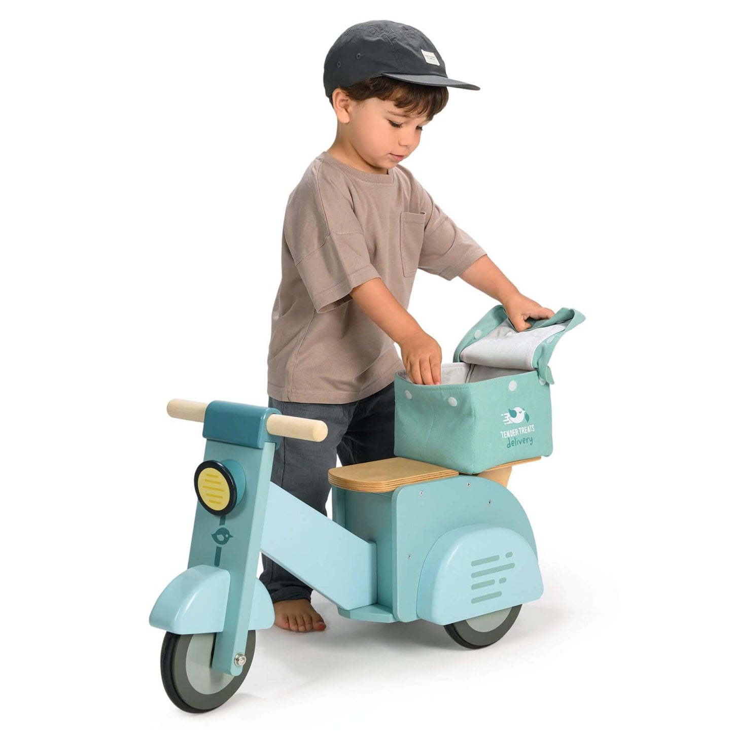 Child playing with Tender Leaf Delivery Scooter on a white background