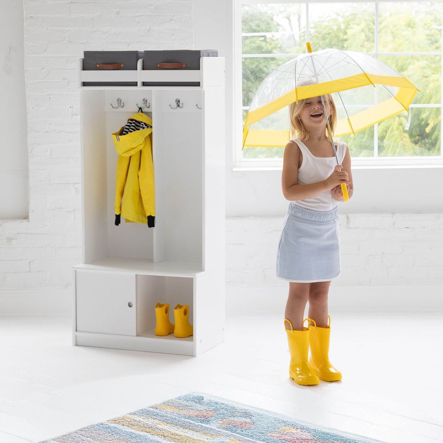Girl Holding Umbrella next to Little Partners Deluxe Cubby White