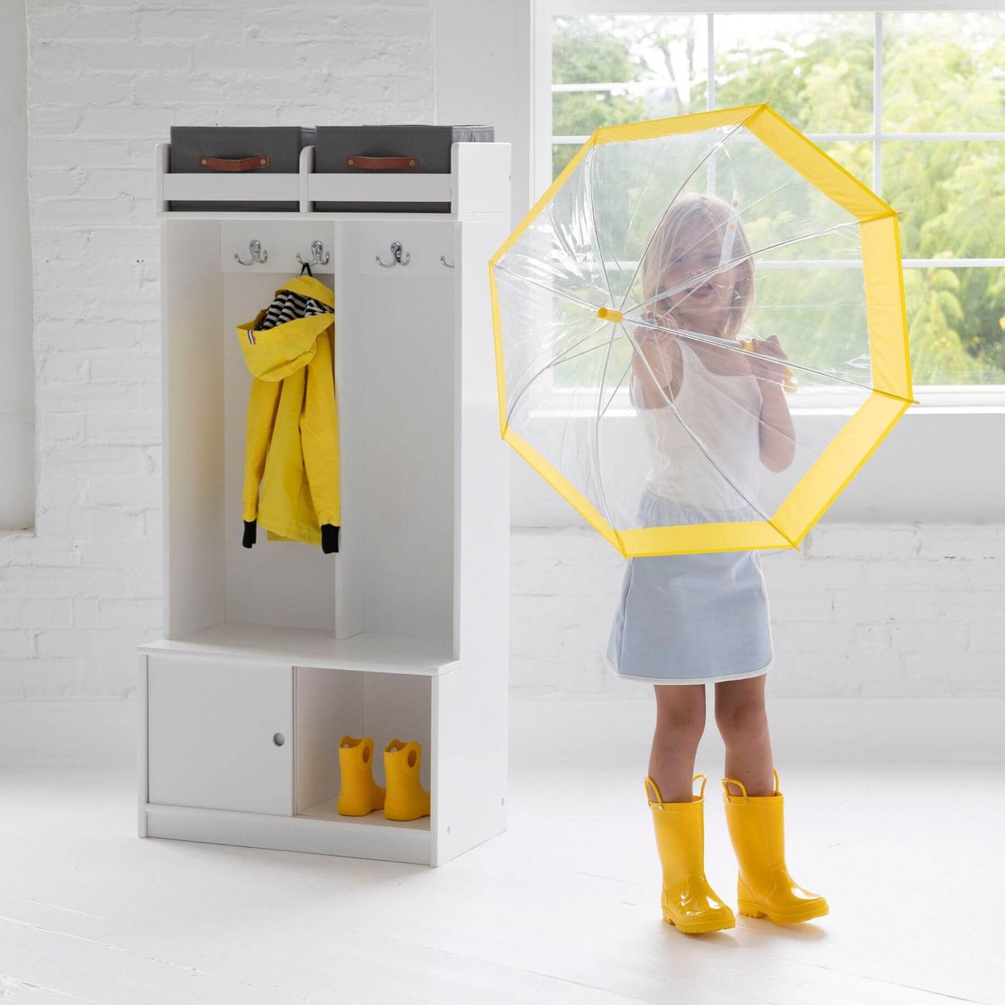 Girl Holding Umbrella next to Little Partners Deluxe Cubby White