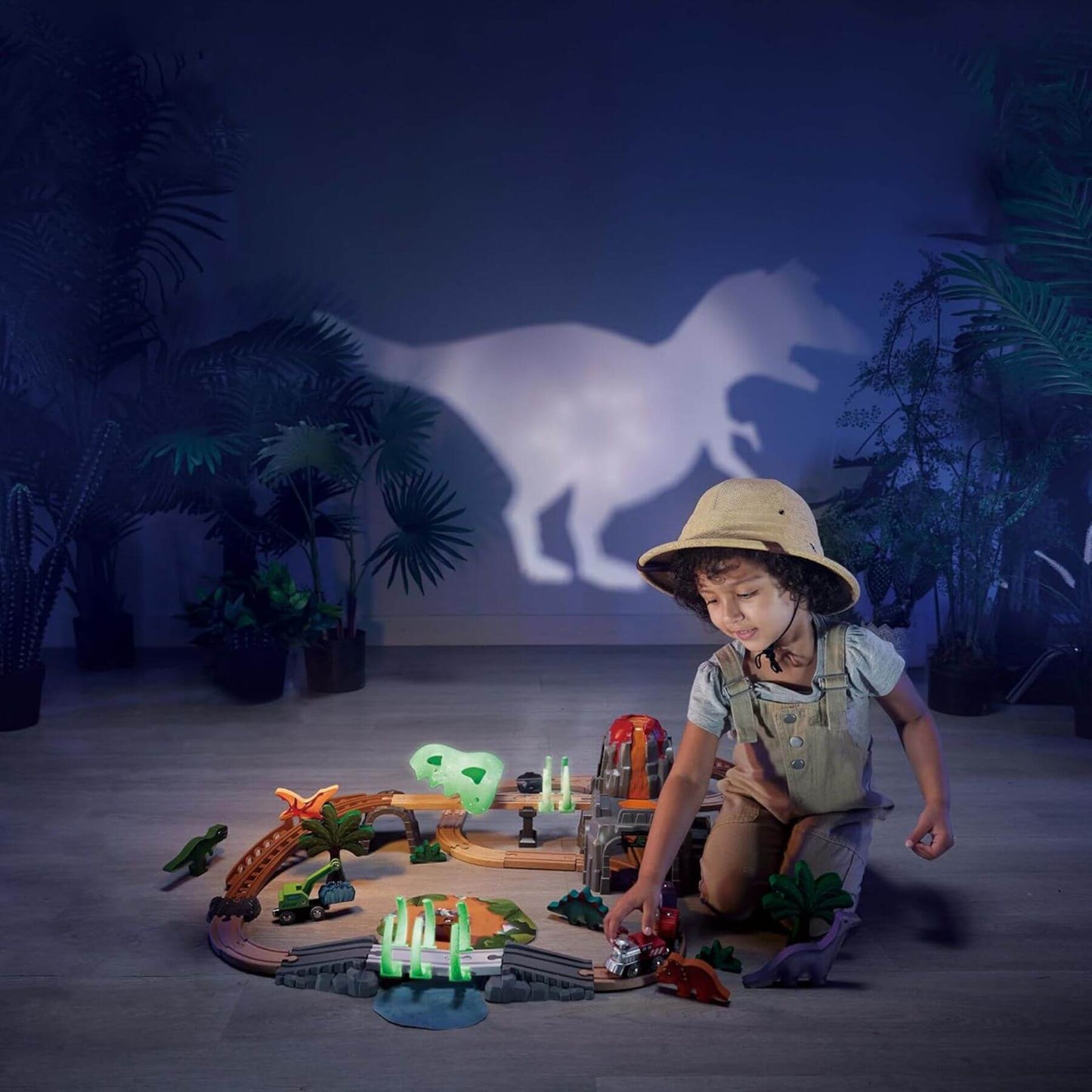 Boy Playing Hape Dinosaur Railway Adventure Set