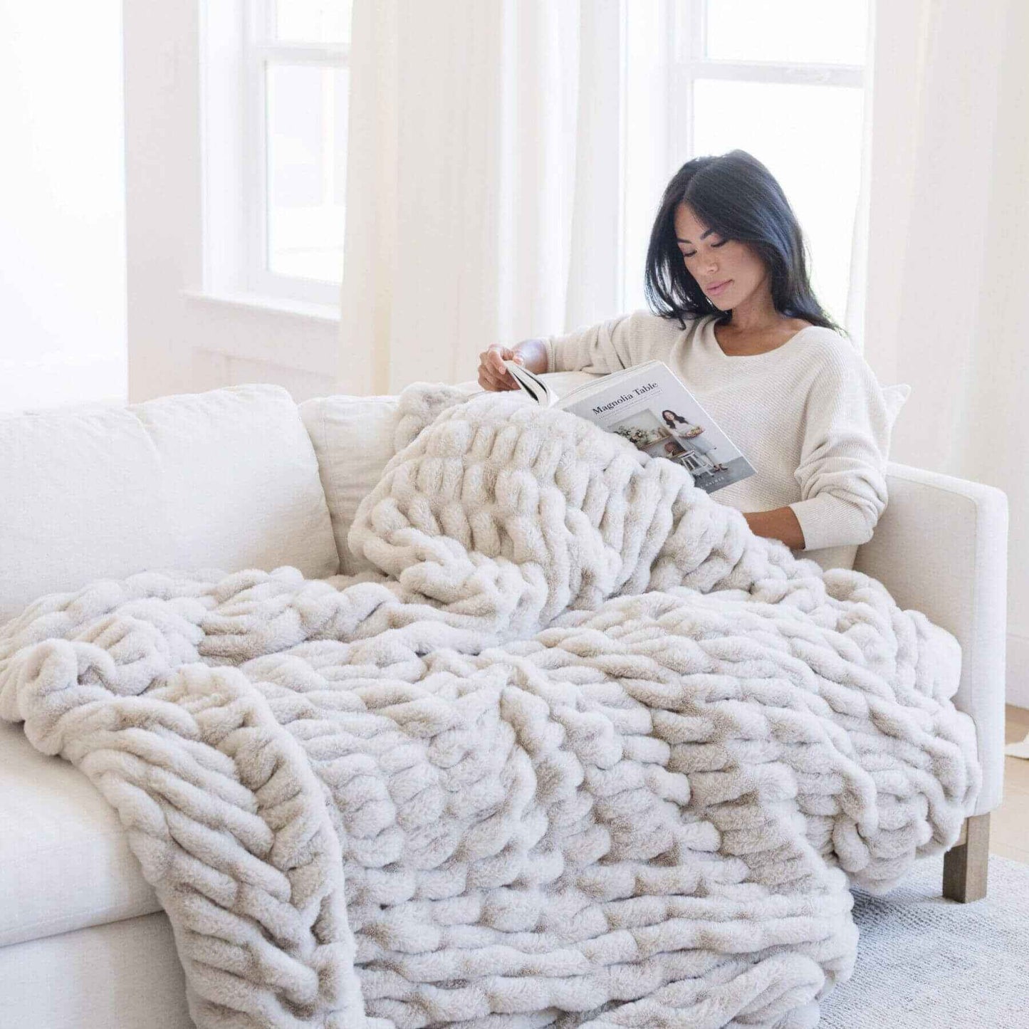 Woman Reading under Saranoni Double Ruched Faux Fur Throw Blankets Flax
