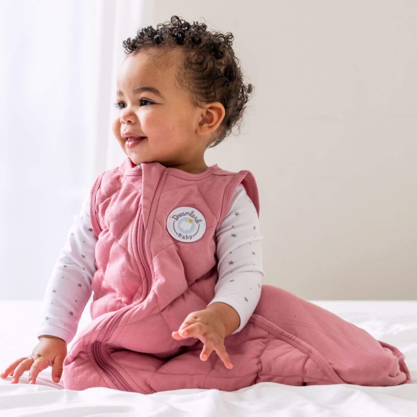 Baby wearing Dreamland Baby Dream Weighted Sleep Sack Dusty Rose