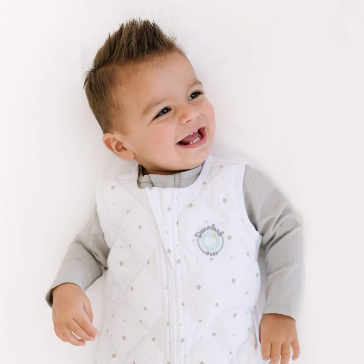Child wearing Dreamland Baby Dream Weighted Sleep Sack Grey Star