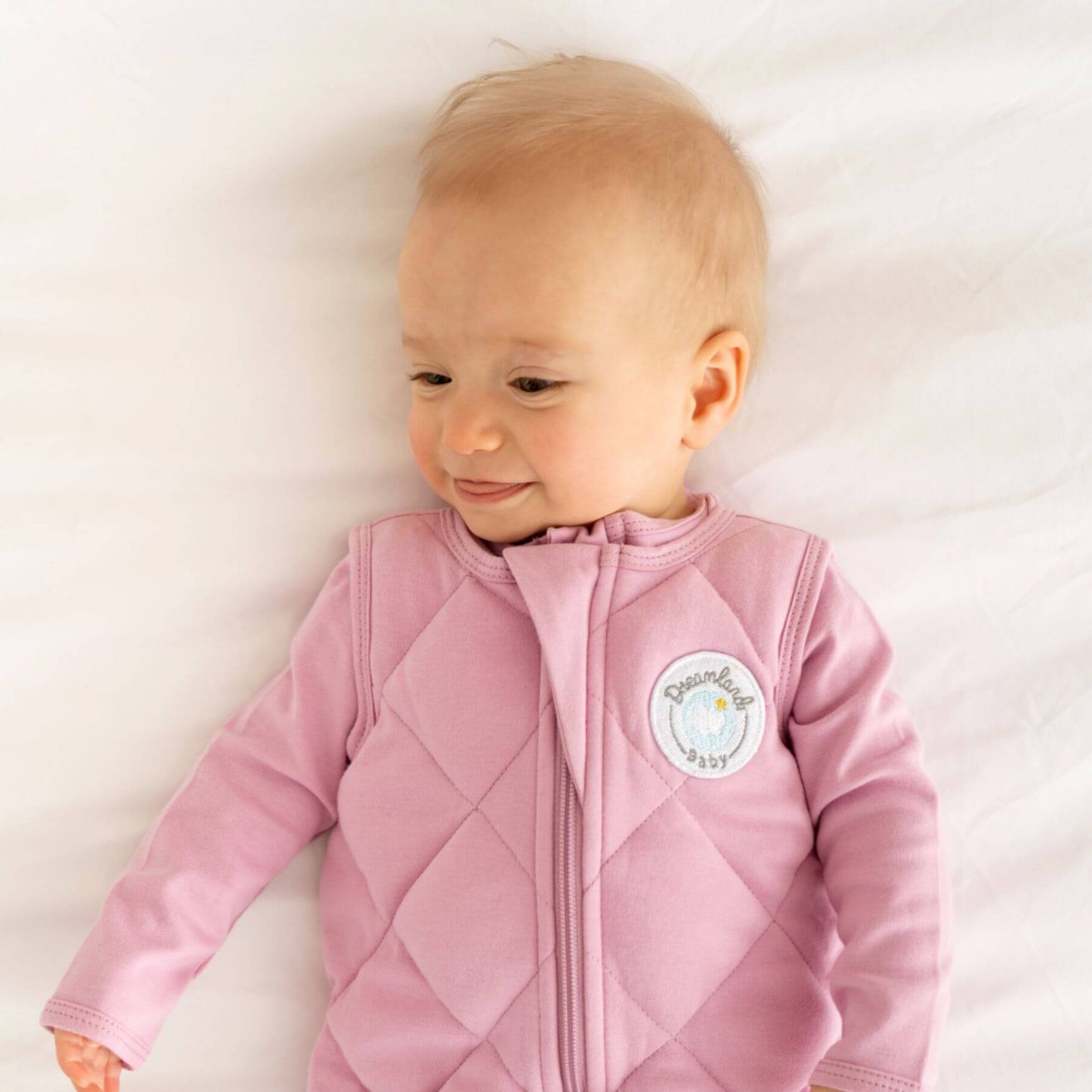 Baby wearing Dreamland Baby Dream Weighted Sleep Sack Misty Mauve