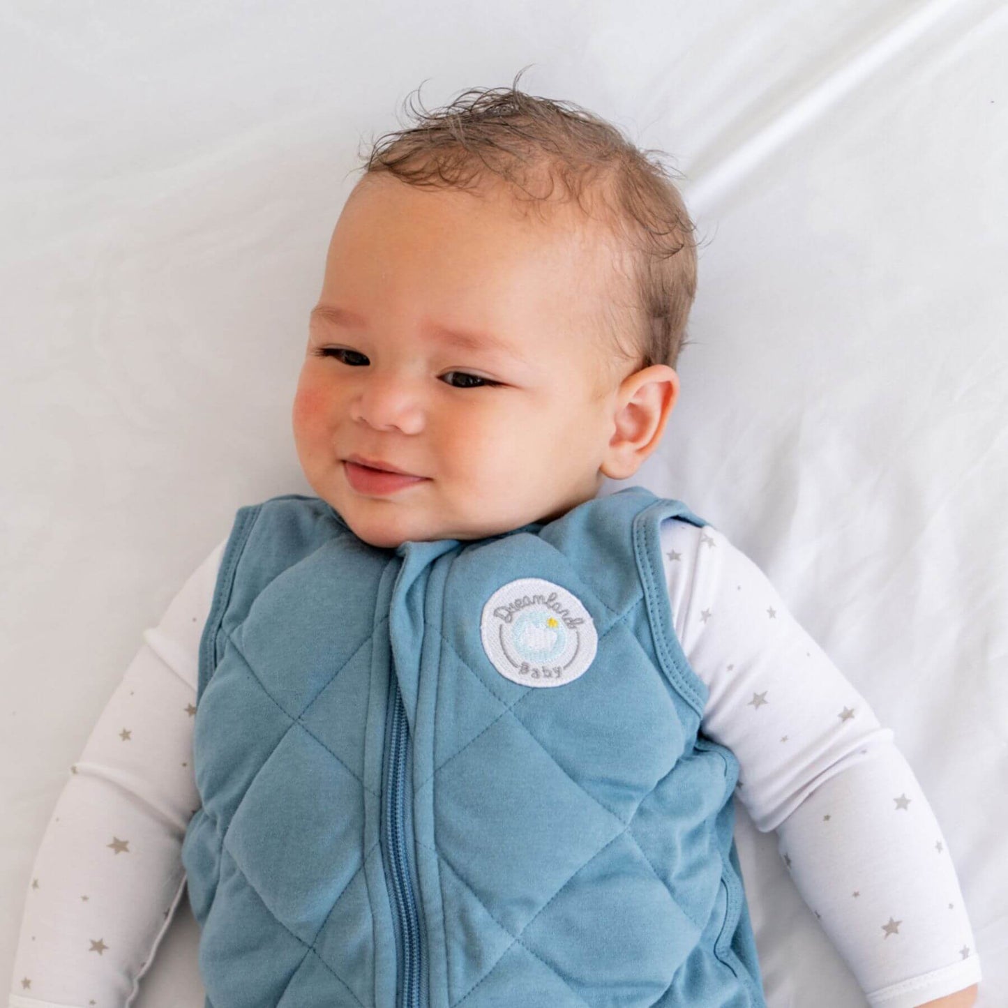 Baby wearing Dreamland Baby Dream Weighted Sleep Sack Ocean Blue