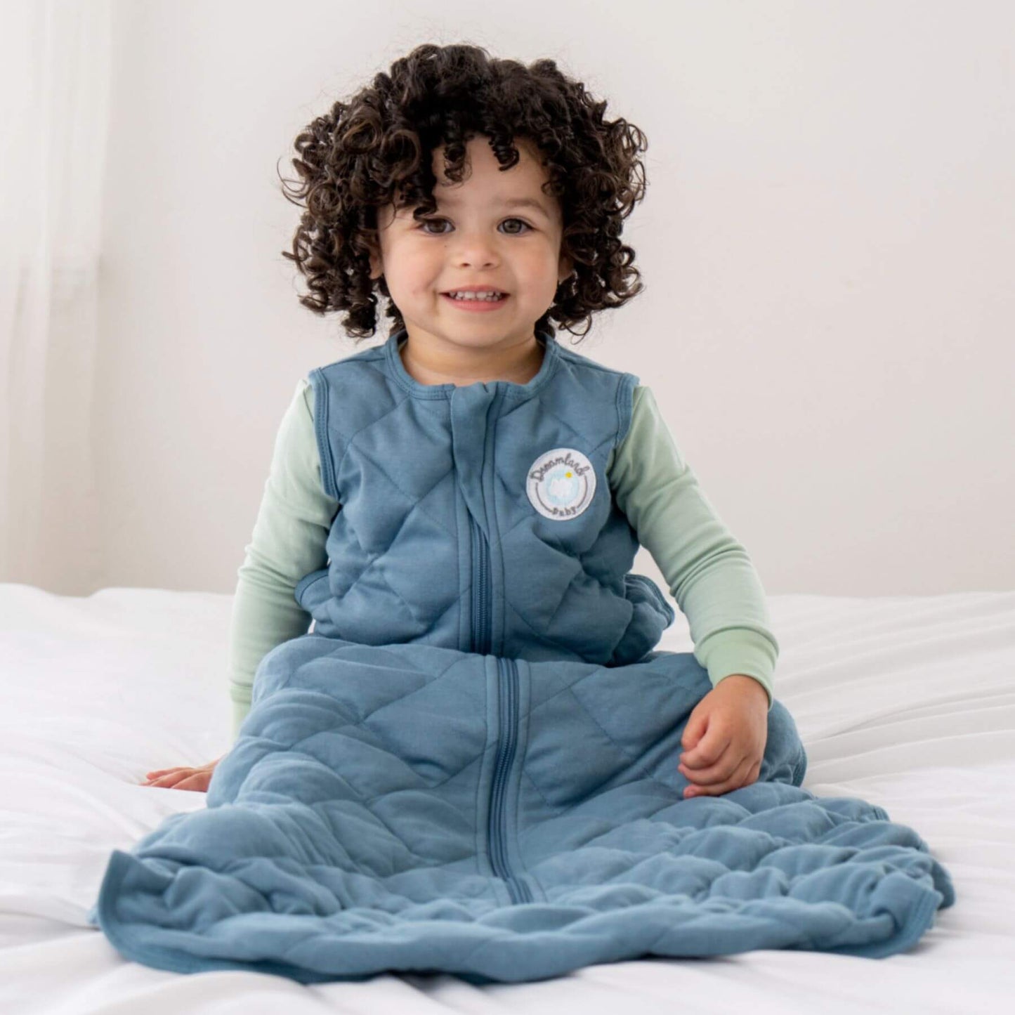 Child wearing Dreamland Baby Dream Weighted Sleep Sack Ocean Blue