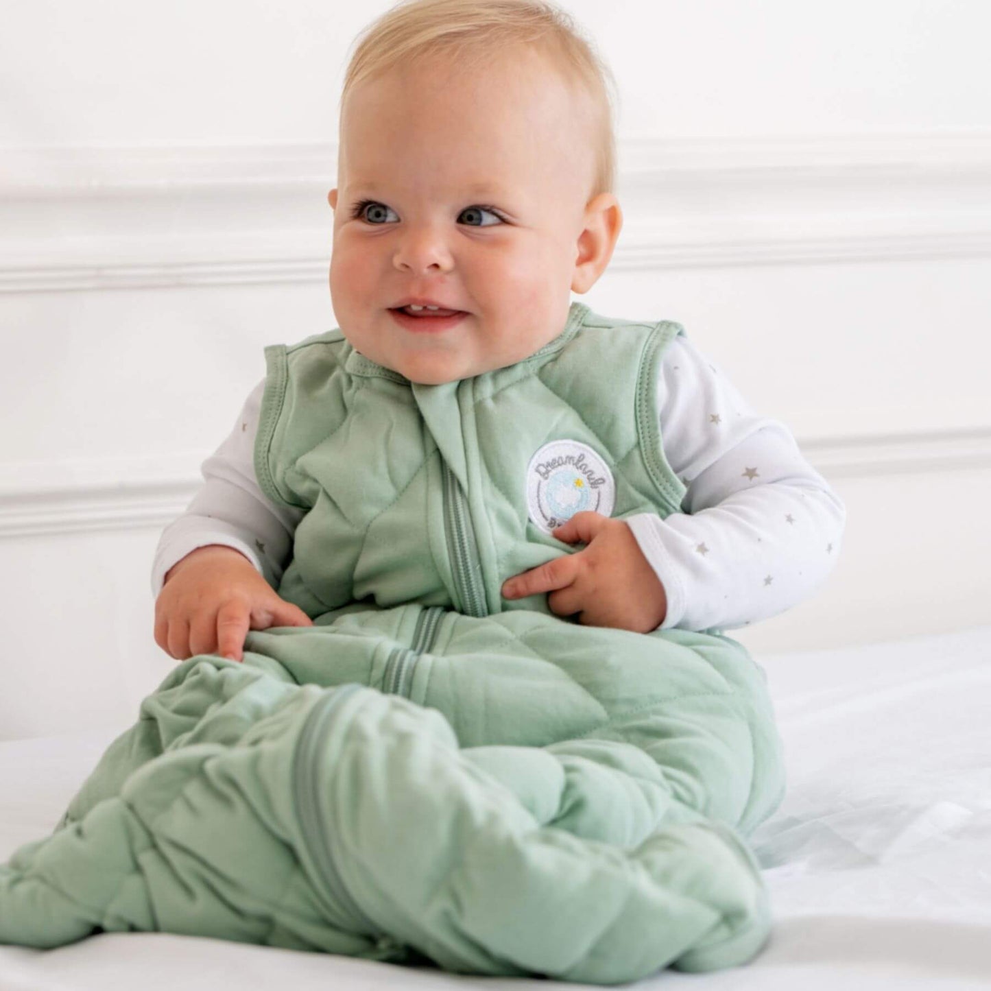 Baby wearing Dreamland Baby Dream Weighted Sleep Sack Sage Green
