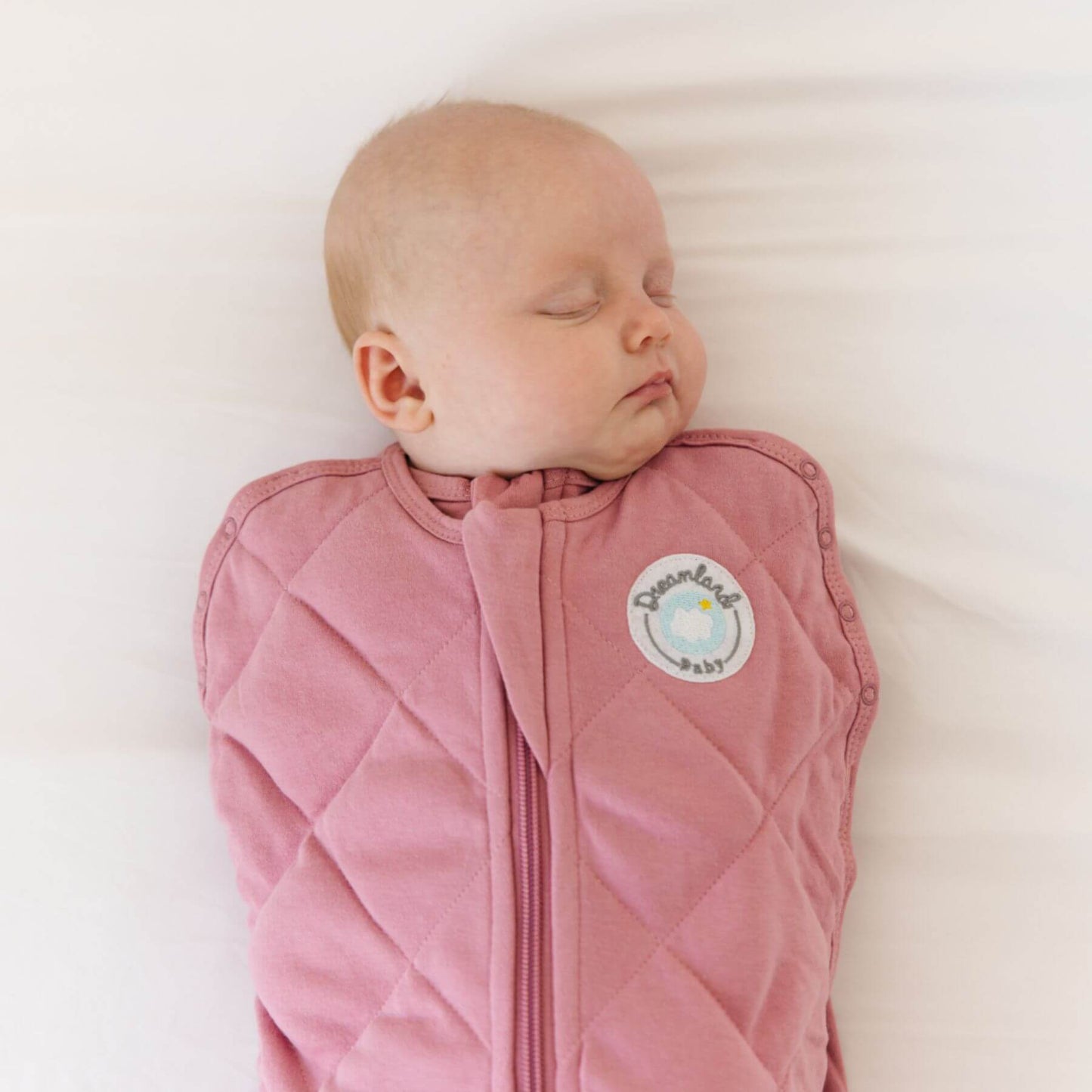 Baby sleeping in Dream Weighted Sleep Swaddle - Rose